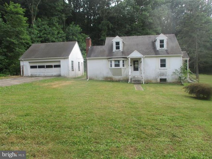 Nice size Cape Cod on huge lot has detached 2 car garage and hardwood floors through-out most rooms. Main level bedroom and full bath. Living room has wood burning fireplace. Kitchen has lots of cabinet space and sliders to rear yard. Separate dining room off kitchen. Upper level has 2 bedrooms with storage. Full basement has endless possibilities & full bath.view docs .OPENS TO INVESTORS 8.6