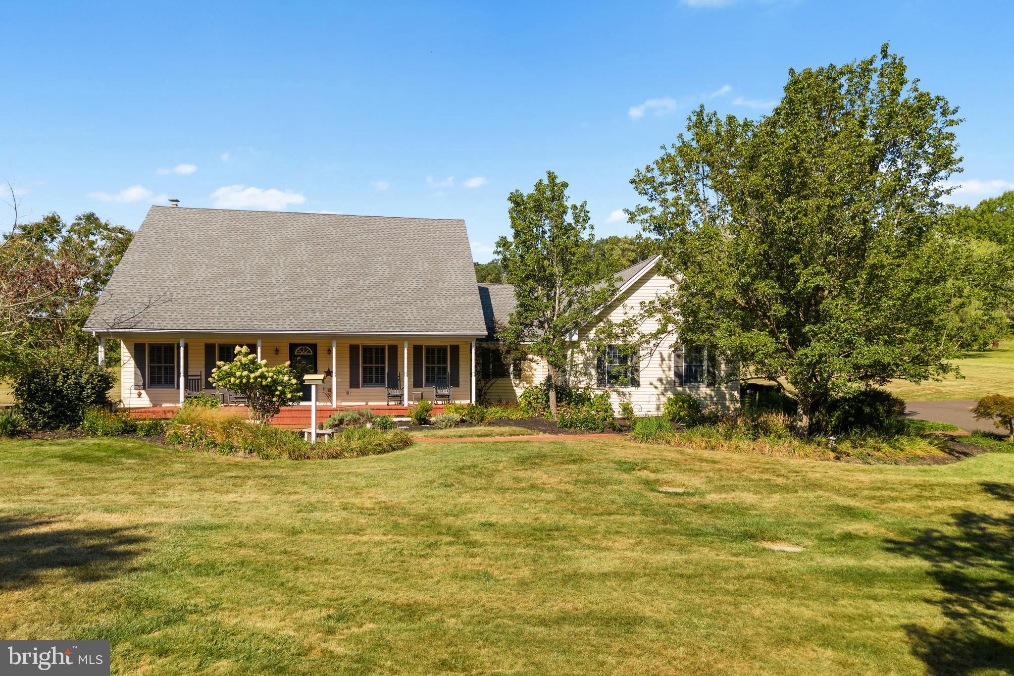 This spacious and beautifully crafted Cape Cod-style home offers 3,200 sq ft of comfortable living space with 5 bedrooms and 3.5 baths, perfectly blending classic charm with modern updates. Set on a peaceful and private lot, enjoy serene mornings and quiet evenings on the inviting front porch—an ideal escape from the hustle and bustle of everyday life. The living room welcomes you with brand-new carpeting (2025), elegant plantation shutters, and an open layout that flows seamlessly into the kitchen. The kitchen offers abundant cabinetry, granite countertops, a double-bowl sink, and a large center island with seating—perfect for casual meals or entertaining. Just off the kitchen, the breakfast room leads through French doors into a sun-drenched sunroom with backyard views. A formal dining room with three oversized windows brings in an abundance of natural light and overlooks the beautifully landscaped yard, making it ideal for hosting gatherings. The primary bedroom suite is thoughtfully set apart from the main living areas, offering a quiet retreat with shiplap accents and a stylish barn door. The spa-like ensuite bath (remodeled in 2020) includes: Double bowl vanity, Freestanding soaking tub, Walk-in tiled shower with built-in niches, Private water closet, and His-and-her walk-in closets. Two additional generously sized bedrooms are located on the main floor, each with its own walk-in closet. They share a well-appointed Jack and Jill bathroom, complete with private dressing areas and individual sinks—making it a great option for family, guests, or even a potential in-law suite. Also on the main floor is an oversized laundry room with plenty of storage and workspace, along with an updated powder room for added convenience. Upstairs, you’ll find two enormous bedrooms that offer endless flexibility—ideal for teens, guests, a home office, or hobby space. An updated full bathroom (2025) serves this level with fresh, modern finishes. Step outside to a beautiful paver patio with an electric awning, perfect for relaxing or dining al fresco. The private, partially fenced backyard features a cozy firepit area—an ideal spot to gather and enjoy the scenic setting. Additional Features & Updates: Full walk-out basement, 2-car attached garage with extra storage space. Roof: 2020, Primary Bedroom & Bath Remodel: 2020, Upstairs Bathroom Remodel: 2025, New Septic Pump, Electric Line & Alarm Panel: 2023, Water Heaters: 2021 & 2025, HVAC System: 2021, Living Room Carpet: 2025. This home is one of a kind!