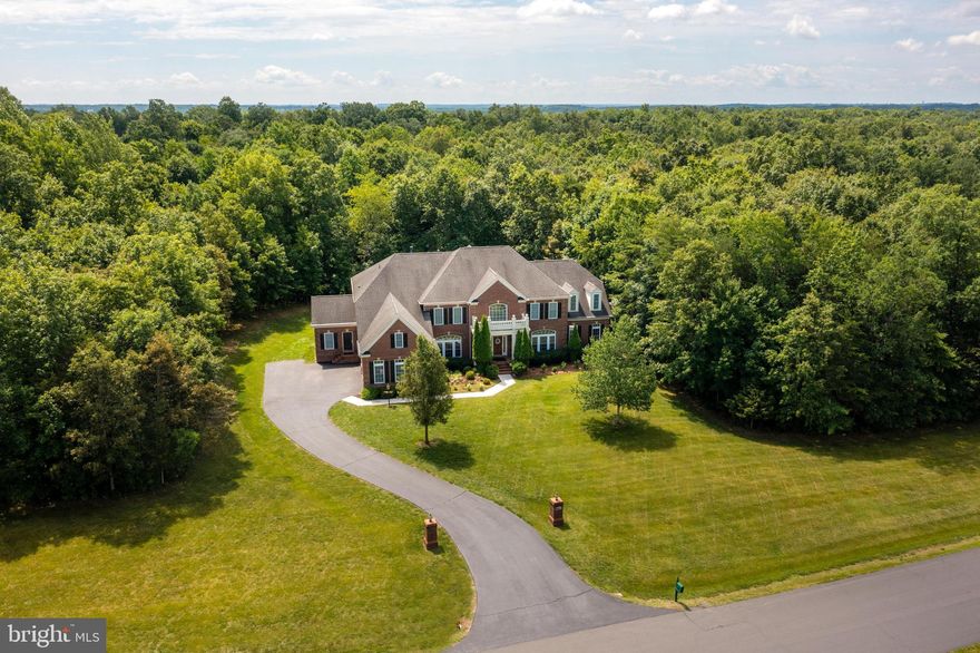 Don't let this one get away! Welcome to your new home!  This gorgeous 3-level estate home is tucked away in the highly sought after and upscale neighborhood of Cedar Crest. Perfectly situated - backed to the woods on over 3 acres of privacy. Inside your dream home, there is a room for every activity - from entertainment to relaxation. With 7 bedrooms, 7.5 bathrooms and a side-entry 3 car garage, there is ample room for any size family to reside and thrive.  The main level features a gorgeous sunroom, a cozy sitting room conveniently located beside a gourmet kitchen, a spacious home office space (that easily converts to a bedroom) and a properly designed laundry room with plenty of cabinet & counter space.  The upper level boasts a total of 6 bedrooms and 5 full bathrooms, with additional laundry space to be found inside an elegant primary bedroom. Once you’ve set foot in the walk-in closet or into the lounge of the master bedroom, you will find yourself in a haven within your home - a place of respite and relaxation.  When entertainment is on your itinerary, the lower level holds ample space for recreation! With a built-in bar and an additional bedroom-bathroom combo for any guests that decide to stay the night.  Established at 8,519 finished sq. ft, this charming, yet private home is part of an excellent neighborhood with notable surrounding schools that include:  Buffalo Trail Elementary, Willard Middle School, & Lightridge High School. Privacy, luxury, and space come together in harmony at this location, showing you what is possible to call “home”.  Move-in ready and ideally situated to enjoy the best that Loudoun County has to offer - Near Bull Run Stables, South Riding Golf Club, Pleasant Valley Golf Club, Chantilly National Golf & Country Club, and The Winery at Bull Run. Convenient access to Rt 50, Rt 66, and Dulles Airport (IAD). Minutes from the heart of Chantilly, Wegmans, Costco, Walmart, Dulles Expo Center, Target, medical facilities, restaurants and much more! Don’t miss the incredible opportunity to make this immaculate estate home your home today!