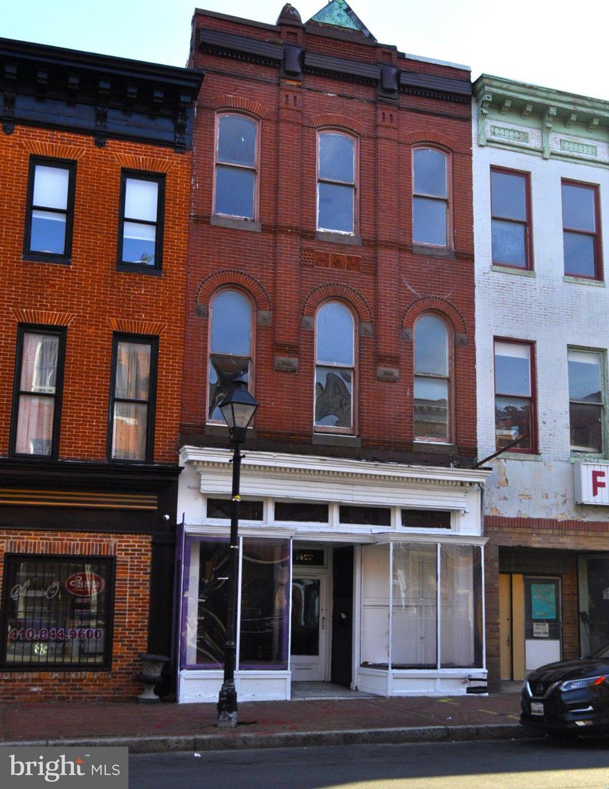 Available in Union Square is a prime value-added opportunity featuring a mixed-use building comprised of commercial/retail space on the ground floor and two residential apartments situated on the second and third floors. The property will be delivered vacant and is ready for customization to suit your preferences.
Nestled within the Union Square-Hollins Market historic district, this Southwest Baltimore neighborhood is renowned for its Italianate and Federal-style rowhomes, as well as its signature 2.5-acre park. Union Square offers a dynamic urban environment, housing art galleries, artist studios, the lifelong residence of H. L. Mencken, and impressive three-story Italianate and Victorian rowhouses. Locally referred to as "Sowebo" (Southwest Baltimore), Union Square is conveniently located less than one mile from Camden Yards and within walking distance of the Inner Harbor.
This historic brick-front mixed-use building resides in a rapidly developing commercial district and boasts beautiful architectural features across three stories. While the building requires cosmetic updates to restore it to its former grandeur, its excellent layout includes a classic storefront with two prominent display windows and an original tin ceiling. The showroom retail area measures approximately 17' x 30', complemented by two additional rooms at the rear and a half bath accessible via the rear entrance, often used by business operators coming from the detached three-car garage. A separate side entrance provides access to the two upper-floor apartments.
The second-floor apartment features a spacious great room accentuated by three tall Art Deco-style windows, providing ample natural light. This versatile space is ideal for a studio, office, or combined living/dining area. Two 15-pane windowed doors open to a full-sized eat-in kitchen. Additional amenities include a full bathroom, a separate bedroom, and a potential second bedroom. The third-floor apartment, while requiring further attention, presents significant potential for comfortable tenant living. With prices still favorable, this represents an attractive investment opportunity. Each unit is equipped with individual water heaters, gas, and electric meters