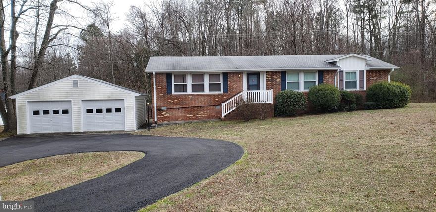 Two lots for one price!  What a great value in King George!  The lot on which the home sits is .46 acre and the attached lot is .64 acre which totals just over 1 acre!  This adorable 1976 rambler is being sold with the adjacent  bonus  lot.  It's a great starter home, investment property or even a great retirement home.  It is located minutes from shopping, medical clinics and Dahlgren NSWC and would be a great investment as a rental property.  It has almost 1300 square feet of living space and features three bedrooms and two full bathrooms.   As you pull into the circular driveway, you can park there or in one of two spaces inside the detached garage.  The garage comes equipped with two garage door openers and has a side entrance.  Once you step into the entry foyer of the home, the living room will be on your left, the kitchen straight ahead and the hallway leading to the three bedrooms to your right.  The living room is large and brightly lit by the large windows that expand most of the wall.  Just off the living room is the large dining area and large kitchen.   The kitchen of this home is spacious with plenty of counter space  and a laundry closet that comes with a washer and dryer. There is plenty of storage space in this home which is something you don't usually find in older homes.  The house has new carpet throughout and is move-in ready and solid .  It has great bones and just needs a bit of updating (fresh paint and other updates).  It's a great little  home for the price.  Definitely worth a look!