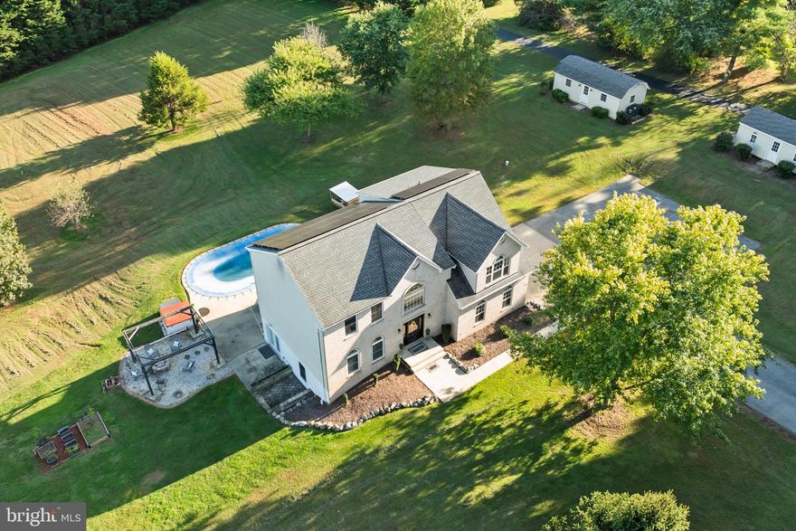 Listed according to recent appraisal — offering excellent value in today’s market!  Three Secluded Acres in Northern Calvert! Enjoy country living with the convenience of a short commute to Washington, D.C., Northern Virginia, Andrews AFB, and surrounding cities. Properties with this much land and so many amenities in Northern Calvert are a rare find!  Spend your days by the in-ground pool or gathered around the fire pit beneath a lit pergola. A spacious enclosed rear porch with a custom wood-plank ceiling overlooks the tree-lined backyard, creating the perfect setting to relax or entertain.  Step inside to a welcoming two-story foyer that leads to the newly remodeled kitchen, featuring crisp white cabinetry, a marble backsplash, granite countertops, and stainless steel appliances. Engineered hardwood flooring flows throughout the main level, including the family room with a cozy gas fireplace, the dining room, and a private office. A full bath with custom ceramic flooring completes this level.  Upstairs, the huge primary suite offers a sitting area, two walk-in closets, and a wood-plank ceiling. The spa-inspired bath includes a tiled walk-in shower with a waterfall head and six jets, a freestanding tub, and dual vanities with marble backsplash.  The fully finished walkout basement serves as a complete in-law suite with its own entrance, full kitchen, large bedroom, laundry room, and plenty of natural light — ideal for extended family, guests, or additional living space.  Additional features include a side-load two-car garage, two large sheds (one with a garage door and one pre-wired for electric), and no HOA restrictions — meaning you can bring your camper, boat, or outdoor toys! The location is equally impressive being just half a mile from top-rated Northern High and Northern Middle Schools and minutes from a park-and-ride, restaurants, grocery stores, and shopping.  Picture moonlit evenings by the pool, a drink in hand at the tiki bar, surrounded by peace and privacy — once you arrive, you’ll never want to leave.