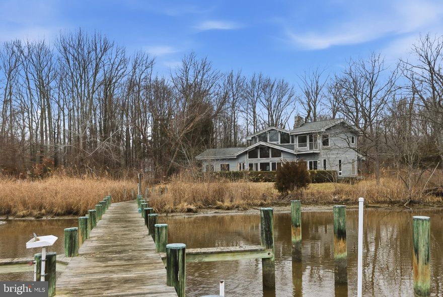 This custom-built waterfront home is a true architectural gem, showcasing extensive cedar woodwork and impressive exposed beams throughout. Warm, rich textures fill every room, creating a sense of natural elegance and timeless craftsmanship. Large windows frame stunning water views, allowing tons of natural light in showcasing all of the architectural detail.

There is a main level primary Suite with Primary Bath and a second level Primary suite and bath!

Nestled in a serene, private setting, this property offers unparalleled tranquility. Mature trees, reeds and thoughtful landscaping provide a natural buffer from the outside world, ensuring peaceful living with every sunrise and sunset. Whether relaxing indoors surrounded by beautiful woodwork or stepping outside to enjoy the calm waterfront, this home offers a rare blend of luxury, comfort, and complete privacy.

Absolutely beautiful in every way, it’s a one-of-a-kind retreat for those who appreciate exceptional design and a connection with nature. The wildlife is ABSOLUTELY  amazing!