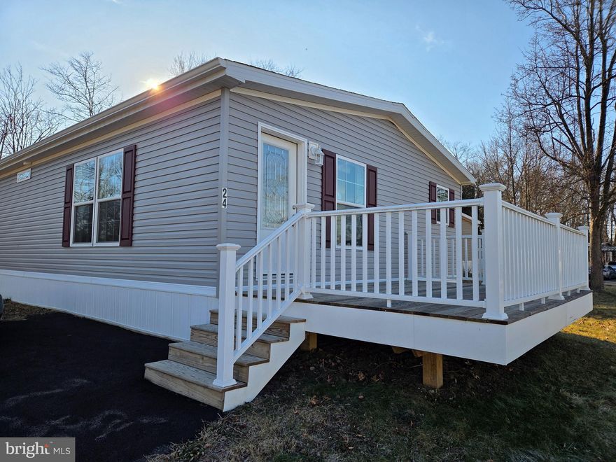 Amazing new 2 bed, 2 bath home on a corner lot that offers many great features. The walk out rear deck leads to a cute yard. The kitchen has recessed lighting, tile backsplash, double stainless-steel sink, and ample cabinet and countertop space which makes the heart of this home a must see! Open concept living all on one floor.  Master has a walk-in closet, bath with shower stall and linen closet.  A separate utility room with plenty of space for a washer and dryer. Home comes with an 8' x 8' shed and a 1-year manufacturer warranty.  The $ 941 monthly land lease includes 1500 gallons of water/sewer use, the pool, mini golf, chip and putt, fishing ponds and use of the community pool for private functions. Park approval required