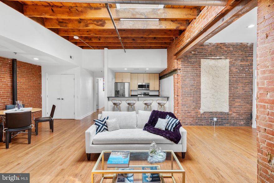 HOLIDAY SPECIAL... FIRST 6 MONTHS HOA PAYMENTS ARE FREE! Bright, spacious, and ideally situated in the heart of Northern Liberties, this condo is packed with charm and ready to welcome its next lucky owner. One of just eight units in a beautifully renovated industrial-style loft building, the home sits on 2nd Street—only a block from the Spring Garden El stop and mere steps from some of the neighborhood’s best bars and restaurants. Enter through a secure keypad-controlled access panel, then head right into the shared, pet-friendly courtyard or make your way upstairs to your private unit. Once inside, you’ll be greeted by natural light pouring in from a private balcony, multiple windows, and a skylight—highlighting the exposed brick walls and warm hardwood floors throughout. The open-concept main living area is perfect for entertaining, with high ceilings and an easy flow to your outdoor space or the kitchen’s bar-height counter. The kitchen itself features updated stainless steel appliances (2023), granite countertops, and plenty of cabinet storage. Off the dining area, you’ll find the washer, dryer, and a well-maintained HVAC system (installed 2019, serviced in 2023), all neatly tucked away in closets. The two spacious bedrooms sit on opposite sides of the main living area, each offering generous closet space, high ceilings, exposed brick, and their own full, sunlit bathroom. The Condo/Coop fee covers, water, common area, building cleaning, management fees, building insurance, intercom, alarm monitoring, trash and snow removal. If you’re looking for a stunning, move-in-ready condo in one of Philly’s most vibrant neighborhoods—this one checks every box!