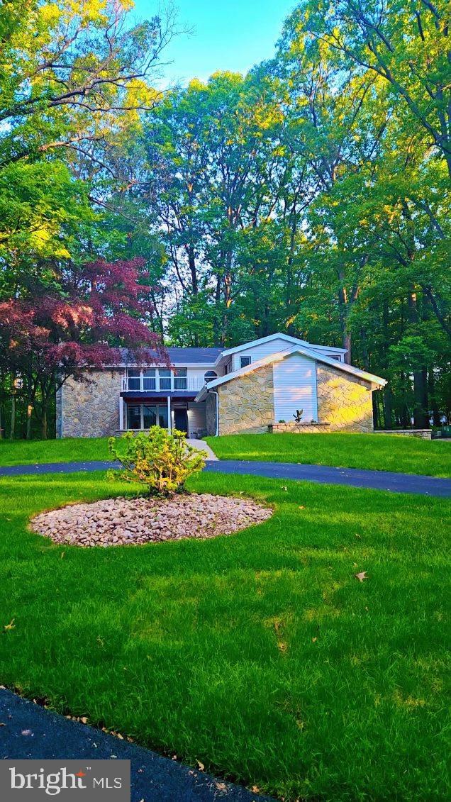 Spectacular Derry Township Home with 3 + acres and Upgrades Throughout. New Heat Pumps, New A/C Units and New Roof and Gutter Guards! As you enter, the spacious living room greets you with an abundance of natural light, 16 foot ceilings and a cozy fireplace- the ideal space to read a good book or hang out with friends. The Open Plan flows into the dining area which can comfortably seat 10, plus a beautiful stone feature wall and another fireplace creating ambience. The kitchen will be the heart of the home with new custom cabinetry, new stainless steel appliances and a tile backsplash. The large island with upgraded countertops will be a great for food preparation or a good spot to complete homework. The den has its own wet bar- making entertaining a breeze. Working remotely? Enjoy the first level office with loads of natural light. In addition, the Murphy Bed makes it a perfect spot for guests or in-laws. Just down the hall, a full bathroom with a walk-in shower, updated lighting and beautiful vanity. The spacious mud/laundry room is conveniently located on the first level. Retire to the primary suite where you can enjoy your morning coffee on the new deck. Loads of closet space will please most shoppers and the primary ensuite with dual sinks and walk-in shower has a spa like feel. Two additional good size bedrooms and two more full baths make it easy to get ready for work or school. Enjoy the view of the first level and the wooded setting from the balcony.
Watch the big game or host a birthday party in the spacious lower level. The attached two car garage will save you from scraping ice and snow from your vehicle. Home has been appraised and a copy is available at the house Enjoy outdoor living? The spacious 3 acre lot, a rare find in Derry Township, will be the place for you. Host a barbcue, sit by the fire pit or play a game of catch in the yard. Located in the desirable Hershey/Derry Township School District and less than two miles from Hershey Medical Center, schedule your showing today!