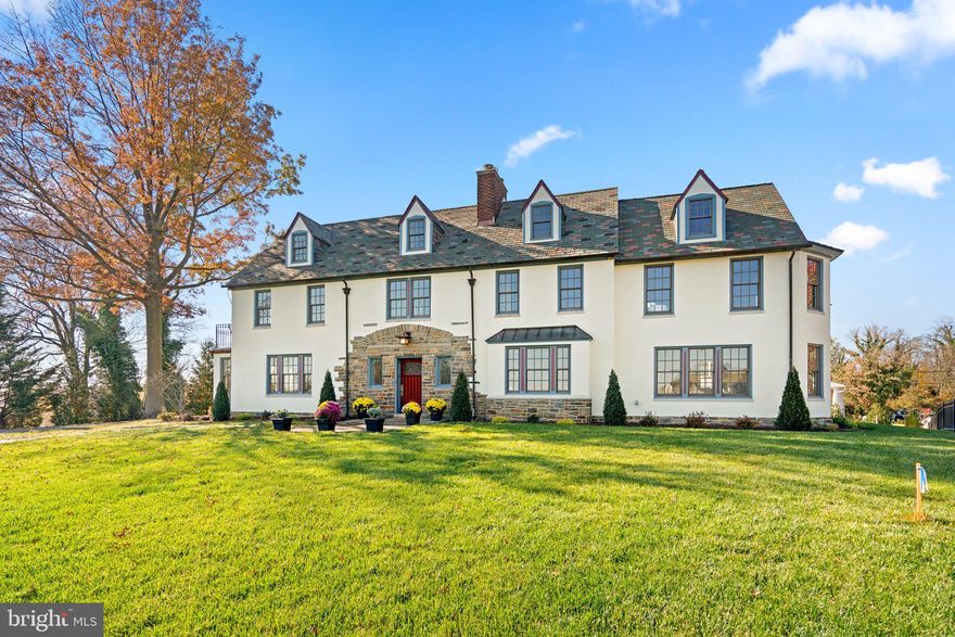 Welcome to Arden House, a timeless masterpiece designed in 1928 by Baltimore architect, William F. Stone, Jr. This stunning residence, built by Frederick May Gittings and Helen Railton Gittings, epitomizes the beauty of Tudor Revival architecture. With its stucco and stone exteriors adorned with half-timbering, numerous Tudor arches, and leaded glass elements, this home stands as a testament to the impeccable craftsmanship and design of a bygone era. This residence, featured as The 33rd Symphony Decorators’ Show House in 2009, holds a unique place in Baltimore's architectural legacy. Meticulously restored and updated, this home seamlessly blends modern comforts with its original charm, creating a perfect harmony of old-world elegance and contemporary living. With over 6,000 square feet of living space, Arden House provides ample room for both grand gatherings and intimate moments. Warm and inviting, with a light and airy color palette and beautiful hardwood floors throughout, history and modern elements coalesce to create a residence that is not just a home but a living testament to the enduring allure of timeless design. This is your opportunity to own a piece of architectural history, where every room tells a story and every detail is a work of art. Enter the house through the Foyer with its stately split staircase, wood-burning fireplace, and leaded glass windows. Off the foyer, the light-filled Living Room, with French door access to a private office, offers the perfect space to receive guests, while the Family Room adjacent to the Living Room has a wall of custom Andersen architectural series replacement windows that bathes the room with natural light. The Dining Room, with original built-ins, is large enough for your next dinner party and a bright sunroom provides an ideal spot for reading a book while enjoying your morning coffee. The heart of Arden House is undoubtedly its dream kitchen, featuring granite counters, an island with a Wolf gas cooktop and seating, stainless steel appliances including a Sub-Zero refrigerator and wine fridge, a butler’s pantry, wet bar, and a convenient warming drawer for effortless entertaining. Custom cabinets with soft-close features and glass fronts provide plenty of storage. Moving upstairs you’re greeted with a generous sitting area that can be used as a study area or reading nook. The expansive Primary Bedroom offers a retreat-like atmosphere with plenty of space for a huge bed and a sitting area. And wait until you see the walk-in closet! It is enormous and customized with a closet system. The luxurious Primary Bathroom includes a classic claw foot soaking tub and a large shower with multiple shower heads. There is also a dual vanity with a custom built-in cabinet and modern LED anti-fog mirrors. Also located on the second floor are two additional nicely sized Bedrooms connected by a Jack-and-Jill bathroom. A large Laundry Room with modern conveniences completes this level. The third floor has another large sitting area that provides versatility as a game room or additional office space, three additional Bedrooms, and a full Bathroom for added convenience. The lower level is partially finished and can be used as a rec room or home gym and has a decorative fireplace. A captivating piece of history, there is a wall safe that adds a unique touch. There’s a large storage room, a utility room, and a full Bath with a stall shower and an original sink to complete this level. Walk-up stairs provide easy access to the backyard. Arden House extends its charm beyond its interiors with a beautifully landscaped yard with views of the city and a long driveway offering ample parking. There's just so much to love about this home & location! NOTE: Garage plans are in documents and permit will be available upon settlement.   Call w/additional questions. Verify schools on the Balt. County Public Schools website.