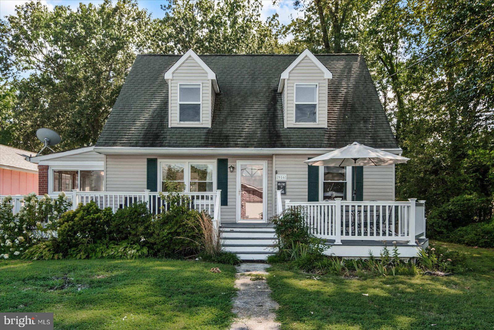 Classic Cape Cod with Water Views, Just a Block from the Potomac
Welcome to 916 Bryant Avenue—charming, coastal, and right where you want to be in Colonial Beach. This 4-bedroom, 2.5-bath home is just a block from the Potomac River and offers classic Cape Cod style with thoughtful updates and plenty of flexible space inside and out.
The main floor features two bedrooms, two bathrooms, an open living area, and a bright eat-in kitchen. Enjoy quiet mornings or sunny afternoons in the enclosed porch turned sunroom, or step outside to the large front deck for river breezes and water views. Upstairs, two additional bedrooms share a full bath, offering space for guests, office needs, or more.
Out back, the detached 2-car garage (accessed from Garfield Ave) includes a finished loft space above—ideal for an art studio, workshop, or home gym. A private rear patio creates the perfect setup for outdoor dining, entertaining, or just unwinding.
Located just minutes by golf cart to the restaurants, boutiques, breweries, coffee shops, pier, beach and boardwalk of downtown Colonial Beach.