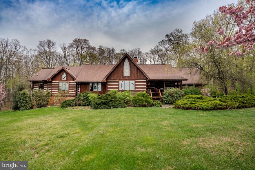 Welcome to a truly one of a kind custom home nestled on over 7 private wooded acres in sought-after Sykesville. 🌲🦌 Located at 1720 Charles Ray Acres Drive, this extraordinary estate blends timeless craftsmanship, rich history, and modern comfort across more than 7,200 finished square feet with 6 bedrooms, 4 full baths, multiple garages, resort-style outdoor amenities, and incredible entertaining spaces.

From the moment you arrive via the private half-mile paved circular driveway, you’ll appreciate the attention to detail and character throughout. The home showcases authentic log construction, soaring vaulted and beamed ceilings, oversized Andersen 700 Series picture windows, and stunning architectural elements sourced from historic properties. The stained-glass window in the front room was salvaged from a Pennsylvania church dating back to the 1850s, while the clawfoot tub in the primary suite carries its own historic story and has been beautifully restored with solid brass fixtures.

The heart of the home is designed for gathering and entertaining. The family room features a full masonry oversized fireplace complete with a brick oven, while the main fireplace includes a Hampton wood-burning insert capable of heating the home through radiant heat. Custom Amish crafted features are found throughout, including the entertainment center milled from trees harvested directly from the property, handmade vanities, black walnut cabinetry in the butler’s pantry, custom live-edge mirrors, and built-in closet systems.

The gourmet kitchen is equipped with commercial grade appliances including a Wolf oven, Thermador hood, double refrigerator, Maytag stainless dishwasher, reverse osmosis water system, oversized island, and handcrafted live-edge serving station. The adjacent butler’s pantry provides additional prep space, power, and custom cabinetry.

The luxurious primary suite offers a spa-like bath with slate flooring, a restored clawfoot tub, custom Amish-built double vanity, walk-in shower with Schluter system, built-in gun safe, and handcrafted spiral staircase designed by a blacksmith using wood milled from the property. Additional bedrooms include newly carpeted main-level rooms and a renovated loft suite with private bath completed in 2023.

The fully finished walkout lower level provides exceptional additional living and entertaining space featuring a custom bar area 🍻, spacious family room, recreation room, additional bedroom and full bath, plus French doors leading directly to the outdoor entertaining areas.

For the outdoor enthusiast and hunter alike, this property is truly unmatched. 🦌🌲 The private wooded acreage offers exceptional seclusion, established walking trails, a hunting blind/tree stand, abundant wildlife, and the peaceful setting every nature lover dreams of. Whether you enjoy hunting, hiking, ATV riding, target practice, or simply relaxing surrounded by nature, this property delivers the ultimate outdoor lifestyle retreat.

Outside, the property continues to impress with expansive covered porches, beautifully landscaped grounds, walking paths, firepit area 🔥, above-ground pool with electric 🏊, hot tub retreat ♨️, detached 40x30 shop with new lean-to addition, oversized attached garage, detached multi-bay garage space, and abundant parking for guests, hobbies, recreational vehicles, or business needs.

Additional updates and features include:

✨ Four-zone HVAC systems all less than 10 years old
✨ Newer well and pressure tank
✨ Architectural shingle roofs updated in phases including the main house in 2022
✨ French doors to the walkout lower level
✨ Custom iron railings and artisan craftsmanship throughout
✨ 9 garage spaces between attached and detached structures
✨ Peaceful wooded surroundings with exceptional privacy

This is more than a home. It’s a legacy property filled with craftsmanship, history, warmth, adventure, and unforgettable character.