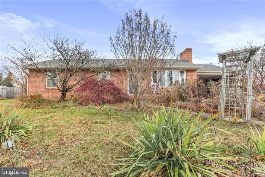 Located in one of the areas most sought-after school districts, this classic brick rancher combines timeless charm with everyday functionality. Built in 1962, the property offers a solid brick exterior and a warm, inviting atmosphere that welcomes you from the moment you step inside. With a thoughtfully designed living space, this home features three spacious bedrooms and one full bathroom on the main level. Natural light is abundant throughout the home. The traditional floor plan flows seamlessly, showcasing beautiful solid hardwood flooring in the bedrooms and main living areas. Gather around the cozy fireplace in the living room, perfect for creating lasting memories with loved ones. The full basement offers ample storage and potential for additional living space. The well-appointed kitchen is equipped with modern appliances,  making meal prep a breeze. Enjoy casual dining in the dedicated dining area, or step outside to the patio for al fresco meals surrounded by nature. Speaking of nature, the landscaping is beautiful in the Spring. Various vibrant flowers are planted throughout the property. Be prepared for a delightful surprise when the weather warms up. While outdoors, the above-ground 17,000 chlorine pool will invite you to unwind during warm summer days or squeeze in your water aerobics. Afterwards you can sit by the fish pond and relax to the sound of the waterfall. The expansive 0.35-acre lot provides plenty of room for outdoor activities, complemented by a convenient shed for your yard tools.  With an attached carport and driveway parking, this home is ready to accommodate your lifestyle. With a new roof installed in 2022, you can have peace of mind that this large expense has been taken care of. The Refrigerator was replaced in 2022, Microwave in 2023, Pool pump in 2023, Water heater in 2020 and a new kitchen sink was added as well. The septic was pumped in 2023. Experience the perfect blend of comfort, convenience, and outdoor enjoyment in this inviting residence.