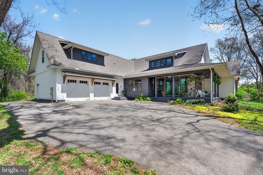 When modern styling meets traditional architectural design the blend can be awe-inspiring.  Welcome to one of those unique homes, set just outside of Historic Shepherdstown on a 2.5 acre property that borders Springdale Farm, a designated historic landmark, this spacious, open floorplan home has luxury features throughout, most notably the soaring vaulted ceilings in the great room and kitchen, and the expansive private patio with a built-in wood-burning fireplace.  Comfort and convenience await with a main floor primary bedroom and bathroom suite that lies adjacent to the gourmet kitchen which is the showpiece of the home with its large island and quartz counter tops, stainless steel appliances and gas cooking, and a view that overlooks the patio and rear yard.  Built for entertaining, the open concept great room features a built-in showcase that's sure to spark discussions of your personal collection next to an inviting floor-to-ceiling stone fireplace where you may quietly enjoy them.  The main floor features two additional guest bedrooms that share a Jack-and-Jill bathroom, but there are additional bedroom options in the private loft and the finished basement - each with an additional full bathroom.  The expansive basement could be easily transformed into an au-pair suite that already features its own laundry connections, as well as a large rec room, a fitness room, and private media room that is perfectly situated for movie night.  With over 5,000 sq ft of living space and striking curb appeal in one of the nation's Best Historic Small Towns (2026 USA Today), this property is the perfect modern contrast to area's timeless past.