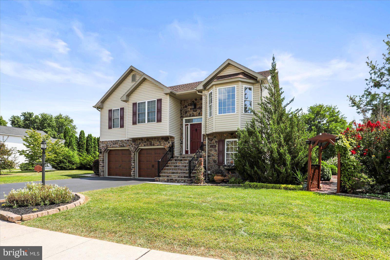 ABSOLUTELY STUNNING remodeled home in Conewago Valley School District! This 3-bedroom, 2.5-bath beauty sits on a serene 0.5-acre lot, perfectly landscaped with gardens, stone paths, water fountain, gazebo, and an outdoor fireplace. The home’s warm woodwork and rustic charm are complemented by modern updates throughout. The main level boasts a spacious living room with vaulted ceilings, exposed wood beams, and access to a covered two-tier deck overlooking the backyard and open common space. The kitchen features stainless steel appliances and bright dining area with bay window. The primary suite offers a private bathroom with relaxing soaking tub ! Step down to a whole new world in the lower level, which includes an amazing family room with a stunning wood-adorned finish, built-in bar, walk-out access, half bath, and laundry room. The oversized garage provides excellent workspace, and the exterior of this home shines with custom stonework, upgraded garage doors, and an inviting entryway. Major updates include a new HVAC system (2017) and water heater (2022) and new roof (2015). This meticulously maintained property is move-in ready—don’t miss the chance to make it yours!