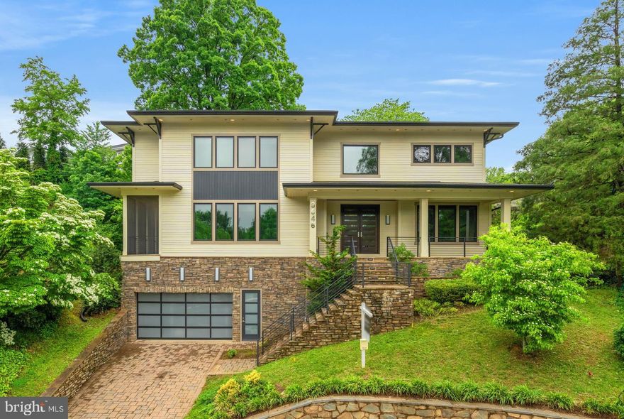 PRICE REDUCTION! 
Welcome to this exceptional residence in the prestigious Country Club Hills neighborhood, ideally positioned on a private cul-de-sac and elevated above neighboring homes for added privacy and presence. This meticulously crafted property offers a refined blend of contemporary design and timeless architectural detail.

A welcoming flagstone patio with beadboard ceiling, and recessed lighting, leads to impressive 8-foot mahogany double doors. Inside, 10-foot ceilings and wide-plank hickory hardwood flooring set the tone for a space that is both expansive and elegantly understated.

The main level’s open-concept layout is anchored by floor-to-ceiling windows that flood the home with natural light and invite seamless connection to the outdoors. At the heart of the home, the chef’s kitchen features waterfall-edge quartz countertops, a generous center island with beverage sink, walk-in and butler’s pantries with beverage center, and a full suite of premium Thermador appliances—including a double oven gas range and oversized refrigerator. The eat-in dining area flows effortlessly into the backyard, perfect for both everyday living and entertaining.

The living room centers around a dramatic indoor/outdoor gas fireplace and opens to a large screened-in porch, providing a comfortable retreat for all seasons. A dedicated home office and powder room complete the main level.

Upstairs, the primary suite offers a true sanctuary with dual walk-in closets and a spa-inspired bath featuring a floating double vanity and a beautifully appointed wet room with soaking tub and separate shower. Three additional bedrooms complete the upper level—one with a private en suite, and two connected by a Jack and Jill bath—offering flexible accommodations for family or guests.

The fully finished lower level is designed for versatility, with a large recreation room and wet bar, a fifth bedroom and full bath, and additional flexible-use rooms ideal for a gym, music studio, or secondary office.

Car enthusiasts will appreciate the thoughtfully designed garage, complete with a 240V EV charging outlet and a car lift for added capacity.

Located minutes from the amenities of North Arlington and Washington, D.C., this residence offers a rare combination of sophisticated design, functional luxury, and premier location.