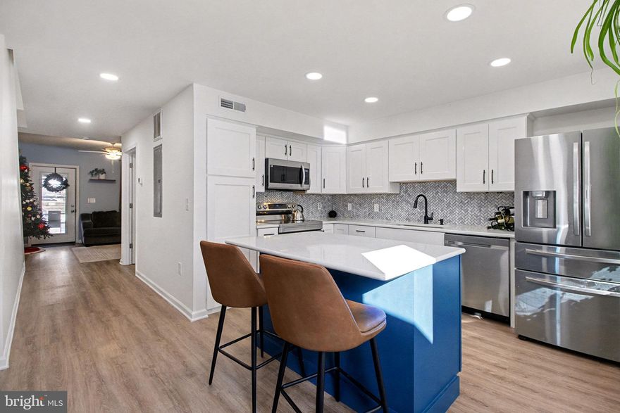 Exceptional condition and truly move-in ready, this contemporary and economical townhome in Petersburg Commons offers comfort, style, and low-maintenance living. The main level features an open combination kitchen and dining area with a brand new island that conveys, quartz countertops, farmhouse sink, custom backsplash. Stainless steel appliances include a built-in microwave, stove, refrigerator, and dishwasher.

Recent laminate flooring installed in 2022 runs throughout the entire home. The main level also includes a convenient half bath with laundry. Upstairs offers three bedrooms and a full bath.  Skylights that fill the space with natural light.  New windows 2022.

Step outside to enjoy extensive high-end landscaping, a completely fenced yard, electric awning, firepit, and outdoor storage. Two paved parking spaces are located directly in front of the home. The property is situated on a cul-de-sac with low HOA fees of just $15 per month.

Located near Routes 322 and 11/15, this home offers easy access for commuting while maintaining a quiet neighborhood setting. With potential 100% financing options available, this is a package that is hard to beat. Move right in and enjoy maintenance-free living. Schedule your private tour today and start your next chapter here.