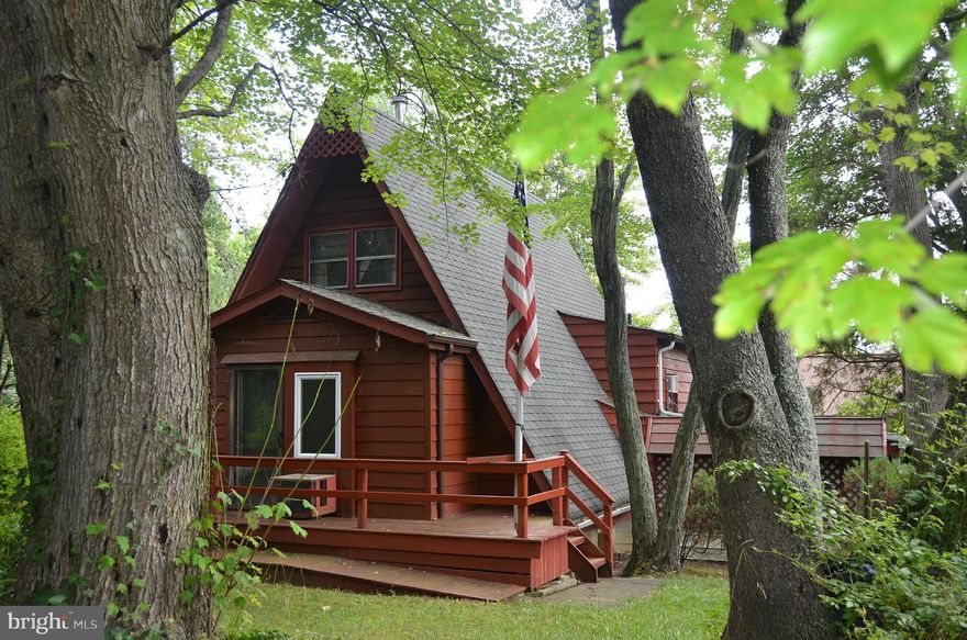 REHAB POTENTIAL--NICE CORNER LOT--TWO BATHS--LOFT--DRIVEWAY WITH CARPORT--SHEDS--GREAT WATERPRIVILEGES WITH COMMUNITY WATERFRONT CLUBHOUSE AT THE BEACH--PLAYGROUND--BOAT RAMP