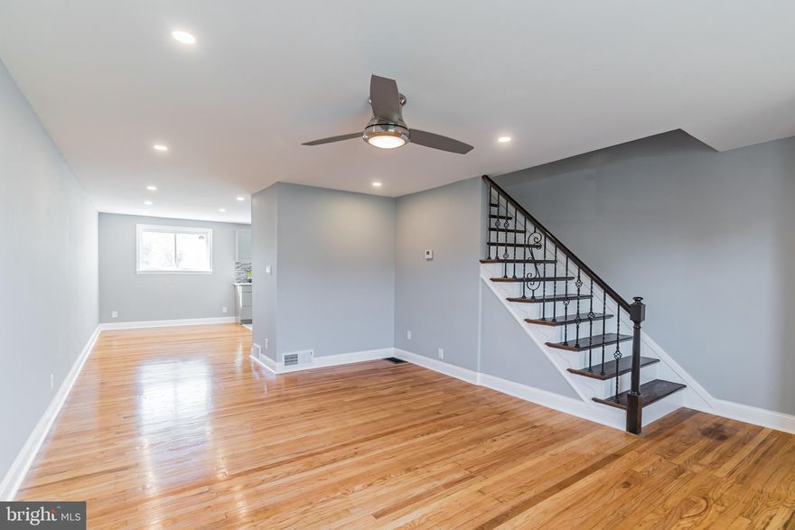 An Incredible value! This home has been extensively renovated inside and out, just bring your furniture! Gleaming hardwood floors, recessed dimmer lighting and  ceiling fan greet you as you enter the front door. As you ascend into the dining room and kitchen you will admire the open concept and attention to detail throughout. The dining room is soaked in sunlight from two oversized sliding windows.  The kitchen offers new stainless steel appliances, quarts counter tops, recessed lighting, and tile backsplash. 3 bedrooms upstiars with finished hardwood floors and new windows. The 2nd floor bath is well appointed with ceramic tile flooring, new tile shower with mosaics, and new light fixtures. The basement is completely finished making for a secluded get away. Basement includes walk out enterence and Full bathroom with stand up shower,  grey tile, & rain fall shower head. This is not just a pretty facade- other major capital improvements include new HVAC system, New water heater, garbage disposal, and new windows throughout. Off street parking for up to 3 cars. This home is truly move-in ready, just unpack and start enjoying your new home!