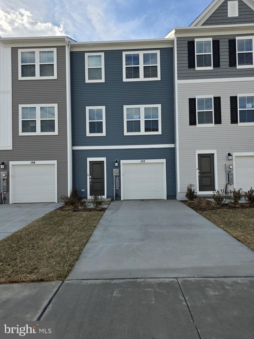 Welcome to The Gallery, one of Martinsburg’s newest communities! Conveniently located near shopping, dining, recreation, and just minutes from I-81, this beautiful end-unit townhome offers added privacy, extra natural light, and enhanced curb appeal.

Enter on the lower level where you’ll find a spacious recreation room — perfect for a home office, gym, or additional living space — along with access to the one-car garage and backyard.

The main level features an open-concept layout with a bright great room flowing into the dining area and kitchen. The kitchen includes stainless steel appliances and ample cabinet space. A convenient half bath is also located on this level, ideal for guests.

Upstairs on the upper level, you’ll find all three bedrooms, two full bathrooms, and the laundry area for added convenience. The primary suite offers a private full bath and generous closet space. Bedrooms two and three are well-sized and share a full hallway bathroom, making this level both functional and comfortable for everyday living.

✨  Homes in this desirable community rent quickly submit your application today and secure this beautiful home before it's gone!