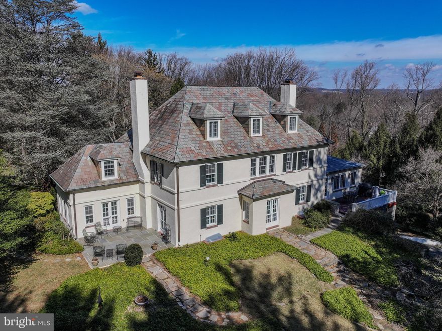 Perched atop the highest point in Ruxton on 2.5 magnificent acres, “Fourwinds” is a rare and extraordinary home that blends historic charm with modern luxury. Built in 1928 by developer Bennett Darnall, this elegant residence offers breathtaking panoramic views and exquisite architectural details throughout. The thoughtfully expanded gourmet kitchen, designed by Trish Houck, features a center island, five-burner gas cooktop with downdraft fan, and a Butler’s pantry, all bathed in the warm glow of the home’s southern exposure—offering stunning sunrises in the morning and golden sunsets across the bluestone patio and sunroom. Outside, the property’s kidney shaped pool, flagstone patio, and deck with natural gas fired grill create a private oasis, perfect for entertaining or quiet relaxation. The open-concept kitchen and family room lead to a mahogany deck with a stone foundation, providing seamless indoor-outdoor living and access to the beautifully landscaped grounds. Designed for both grand entertaining and intimate gatherings, the formal living and dining rooms feature wood burning fireplaces, rich hardwood floors, and elegant original moldings. Upstairs, the primary suite includes its own fireplace, seating area, an en-suite bath, and breathtaking views. Three additional bedrooms and two full baths complete the second level, while the third floor offers two more bedrooms, a full bath, and two cedar closets.  The lower level boasts a spacious recreation room, a large laundry area, and a dedicated workspace, providing ample flexibility for modern living.  Additional highlights include a two-car attached garage, spacious driveway, large storage shed, custom built-ins, a back staircase leading to the second and third floors.  Lovingly restored, updated, and meticulously maintained by its current owners for over 33 years. Nestled in one of Ruxton’s most desirable locations, this residence offers a serene country setting with easy access to major commuting routes, schools, shopping, and dining. A Circle Road lot with BGE natural gas line to the house is included (Tax ID 1600000060). "Fourwinds" is a once-in-a-lifetime opportunity to own a piece of Ruxton’s history.