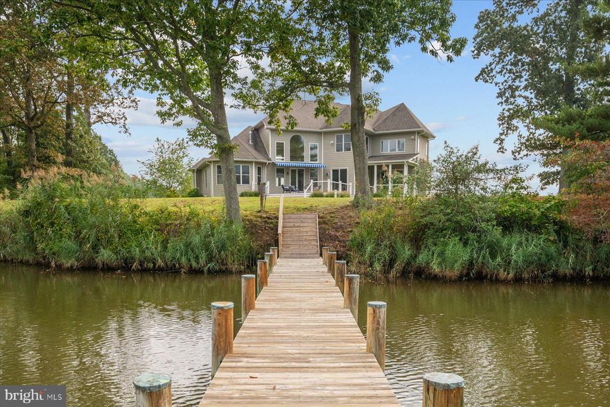 As you make your way down the quarter-mile private road, passing one of the area's last working farms and historic tobacco barns, you arrive at 1576 Bay Head Road—a breathtaking waterfront sanctuary in the historic enclave of Podickory Point. Set on over an acre of beautifully landscaped grounds and boasting 250 feet of unobstructed water frontage along the Little Magothy River, this stunning estate offers an unmatched lifestyle of luxury, tranquility, and effortless connection to the Chesapeake Bay. Built in 2015 with meticulous attention to detail, this 7,000 sq. ft. home invites you to immerse yourself in a world where everyday living feels like a vacation.  Imagine spending the day out on the bay, crabbing, fishing, or exploring the waterways, and returning to your private 60-foot pier, where two boat slips and a spacious landing make docking a breeze. Fully equipped with water and electric, the pier becomes the heart of your waterfront living, whether you’re unloading the day’s catch or hosting friends for an impromptu evening of sunsets and cocktails by the water. Outdoor entertaining reaches new heights with two expansive decks that capture the beauty of the river. One deck is covered for a shaded, serene retreat, while the other features a retractable awning, giving you the freedom to bask in the sun or relax under the shade. These spaces are ideal for summer barbecues, holiday gatherings, or quiet evenings watching the changing colors of the sky reflect on the water.  Step inside, and the home’s sophistication and warmth envelop you. Sunlight pours through walls of windows, illuminating a thoughtfully designed open floor plan that maximizes both comfort and function. The two-story family room, with its soaring ceilings and breathtaking water views, is a showstopper and the perfect backdrop for cozy evenings by the fire or lively family celebrations. The gourmet kitchen is a chef’s dream, featuring top-of-the-line stainless steel appliances, a six-burner stove, and an oversized island that’s perfect for preparing meals or gathering with guests over wine and laughter. Adjacent to the kitchen, the breakfast area offers a front-row seat to the river’s serene beauty, making casual meals feel extraordinary. 
The main-level primary suite is your private haven, where you can wake up to the soft glow of the sunrise over the water. Crown molding, a romantic coffered ceiling, and a spa-like en suite bath with a soaking tub and walk-in shower create a space that is as elegant as it is restful. Upstairs, three additional bedrooms and beautifully appointed baths provide ample space for family and guests, ensuring everyone feels at home. 
Downstairs, the fully finished basement is an entertainer’s paradise. Host movie nights in the private theater room, mix drinks at the wet bar, or let guests unwind in the recreation area while you enjoy a workout in the home gym. The seamless flow of this home makes it just as suited for grand celebrations as it is for intimate gatherings, with every detail designed to bring people together while still allowing for peaceful retreats.
 This property offers more than a home—it’s a lifestyle. Whether you’re crabbing from your dock, kayaking along the shoreline, or enjoying the simple pleasure of sitting on your deck as the water laps against the shore, life here feels unhurried, peaceful, and deeply connected to nature. Despite its serene setting, the home is ideally located just minutes from major commuter routes, including Route 50, I-97, and Route 2, and a short drive to downtown Annapolis, where you can enjoy dining, shopping, and cultural landmarks. 
Perfectly blending timeless elegance, modern convenience, and the unmatched beauty of the Chesapeake Bay, 1576 Bay Head Road is more than just a place to live—it’s a place to create memories, build traditions, and embrace the best of waterfront living. Don’t miss your chance to call this extraordinary property home.