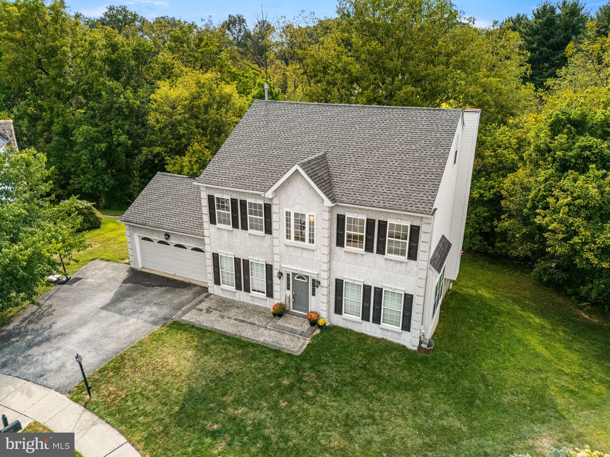 Location, Location! Cozy colonial sits on a quiet cul-de-sac, tastefully updated 4 bed/2.5 bath, 2 car garage, backs to tranquil forest, newly finished (2021) walk-out basement ready for entertainment. Welcoming 2-story foyer, sun-filled expansive formal living room and dining room for your enjoyment. Family room with gas fireplace, updated Kitchen and Butler Pantry, Granite Countertops, stainless double bowl sinks, stylish faucet/backsplash, and appliances. Laundry Room and the Powder Room completes the main level. 2nd Floor hosts an sumptuous main site with frame-less shower stall and double Granite vanity. 3 good sized secondary bedrooms are all well appointed with ample closet space and share a charming Hall Bathroom, featuring ceramic tile flooring, tub-shower, dual vanity. Gleaming cherry hardwood through out both floors. New HVAC installed in 2023. Walk-Up Attic with Rough-In Plumbing and Electrical for a Full Bath is ready for finish. Sought after Washington Crossing, minutes away from the King of Prussia mall, Valley Forge national park, hiking and biking trails, CHOP, and shopping center, Wegmans, Costco, easy access to major HWY.