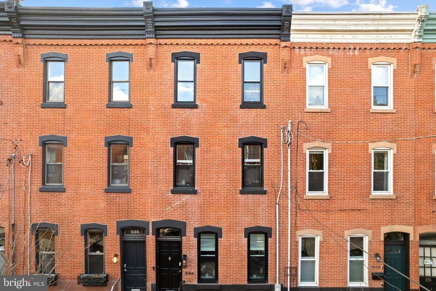 Walk into this beautifully renovated 4-bedroom, 2 1/2-bath Fairmount home featuring a finished basement, stunning west-facing roof deck, custom laundry room, and a one-of-a-kind outdoor chef’s kitchen complete with a wood-fired pizza oven. 

The interior of this Fairmount gem shines with contemporary upgrades as well as original, architectural grace. Millwork in the front vestibule entry, window trim, stairwell and other moldings maintain this 1920 home’s historical integrity.  Its wide-open first floor features 21st century wood flooring extending through the living and dining areas. The kitchen offers Carrara marble countertops with contrasting backsplash, a breakfast bar, and all new or recent stainless steel, Viking appliances. Beyond the kitchen, discover a versatile mudroom equipped with a full-size washer/dryer, custom floor to ceiling cabinetry, and a convenient half-bath. 
Upstairs are two large bedrooms that share a hall bath and a smaller bedroom or office. The finished basement holds a TV and casual dining area, as well as plenty of space for storage. The third level has a main bedroom suite with large, luxury bath featuring a skylight, shower for two, and entrance to a stunning roof deck.

A 2014 renovation took the house down to the studs, creating its finished basement and ensuite third floor. Upgrades completed between 2020 and 2023 include: the installation of a living room gas fireplace built out with marble tile in minimalist design; renovated back patio with slate flagstone floor and rebuilt walls and doors; a first floor, outdoor chef’s kitchen and dining area, including a hand-built, wood-fired pizza oven, three professional-grade gas burners, sink, prep table, and refrigerator; remodeled master bathroom; laundry area cabinets and countertops; and a large roof deck made of Tech composite material that faces west with unobstructed sunset views.

This Fairmount-area street is filled with wonderful people, block parties, dinners with neighbors, and a shared appreciation for the magic of Art Museum Area living.  846 N. 24th Street is just blocks from Fairmount Avenue, Parkway museums, coffee shops, restaurants and a short drive or healthy walk to Whole Foods.