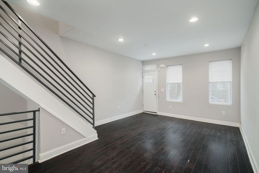 Welcome to 2033 Watkins Street in Point Breeze. Recently fully remodeled in 2016, this spacious 1,009 square foot 2 bedroom home has all of the  modern amenities and comforts you’re looking for in South Philadelphia without the Graduate Hospital or Passyunk price tag. Step into the open floor plan living and dining room with engineered true hardwood plank floors flowing straight through to the kitchen in the rear. The sizeable kitchen offers granite countertops, timeless white shaker cabinets and ceramic backsplash, stainless steel appliances including full dishwasher, built-in microwave, natural gas stove and double door refrigerator. For additional eat-in kitchen seating there is a high-top countertop with overhang bar seating and undermount cabinets. The first floor also features the convenience of a half bath off of the kitchen. The finished basement features wall to wall carpeting and recessed lighting for cozy and quiet additional living space with separate laundry and utility closet in the rear. Head upstairs to see the spacious and private two bedrooms on the front and rear, both featuring hardwood floors, full sized closets, recessed lighting and privacy blinds. The shared full bathroom on the hall has a full sized tub shower with modern rainfall showerhead, twin floating vanity sinks and linen nook. Come check out this booming block with multiple new construction homes and more renovations and new construction homes currently underway. Don’t miss your chance to invest in Point Breeze and make this home your own. Central air conditioning and heat. Roof recently fully silver-coated. Buyers are responsible for verifying current property tax details.