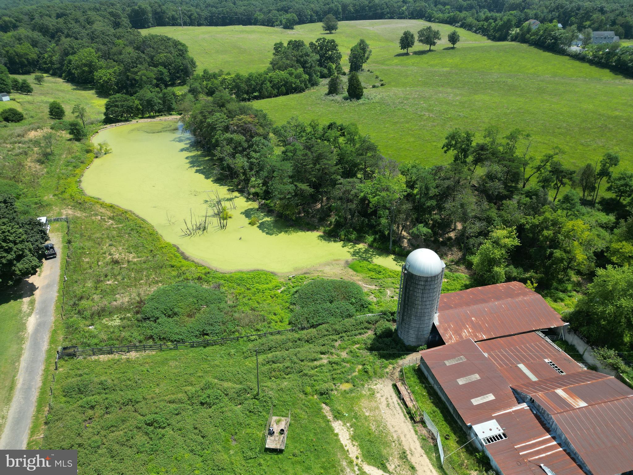Large Berkeley County Farm with Ample Opportunity
This is the farm to buy as you won't find a deal like this anytime soon. Currently this farm is used for hay production in the back half and the cattle graze on the front portion. Every farmer knows you have to have water in order to raise livestock and this farm has plenty of it. Featuring an over 1 acre pond, smaller pond in the feed lot and multiple streams flowing in the back portion, you are sure to keep those animals cool on those hot summer days. Currently the land is broken down into multiple paddocks that could be used for horses, cattle or other types of livestock.
The hay fields currently make up 36 acres of the property. The hills are gentle sloping which allow for water runoff and avoiding soft spots in the fields. The hay fields do have remnants of old fence line that could be repaired or replaced to create new paddocks . There is opportunity for a few more acres to be cut behind the home as well.
This property does hold a sketch plat for development as an addition to Forest Heights. Previous plats showed a potential of 163 single family residential homes scattered across the landscape. Currently Forest Heights utilizes public water and sewer so potential investors would need to exercise due diligence in costs and capabilities of hookup.
Across the back of the farm is a very large oak flat that holds tons of potential. Whethere you are looking to place a secluded home or take advantage of the marketable timber, this block of timber has options. Deriving of roughly 33 acres you can find yourself hidden from the city under the canopy of large oaks.
Don't let the opportunity pass you by of what this farm offers. Secluded home, farm, investment opportunity or future development, this land is waiting for the next owners to make it their own.
