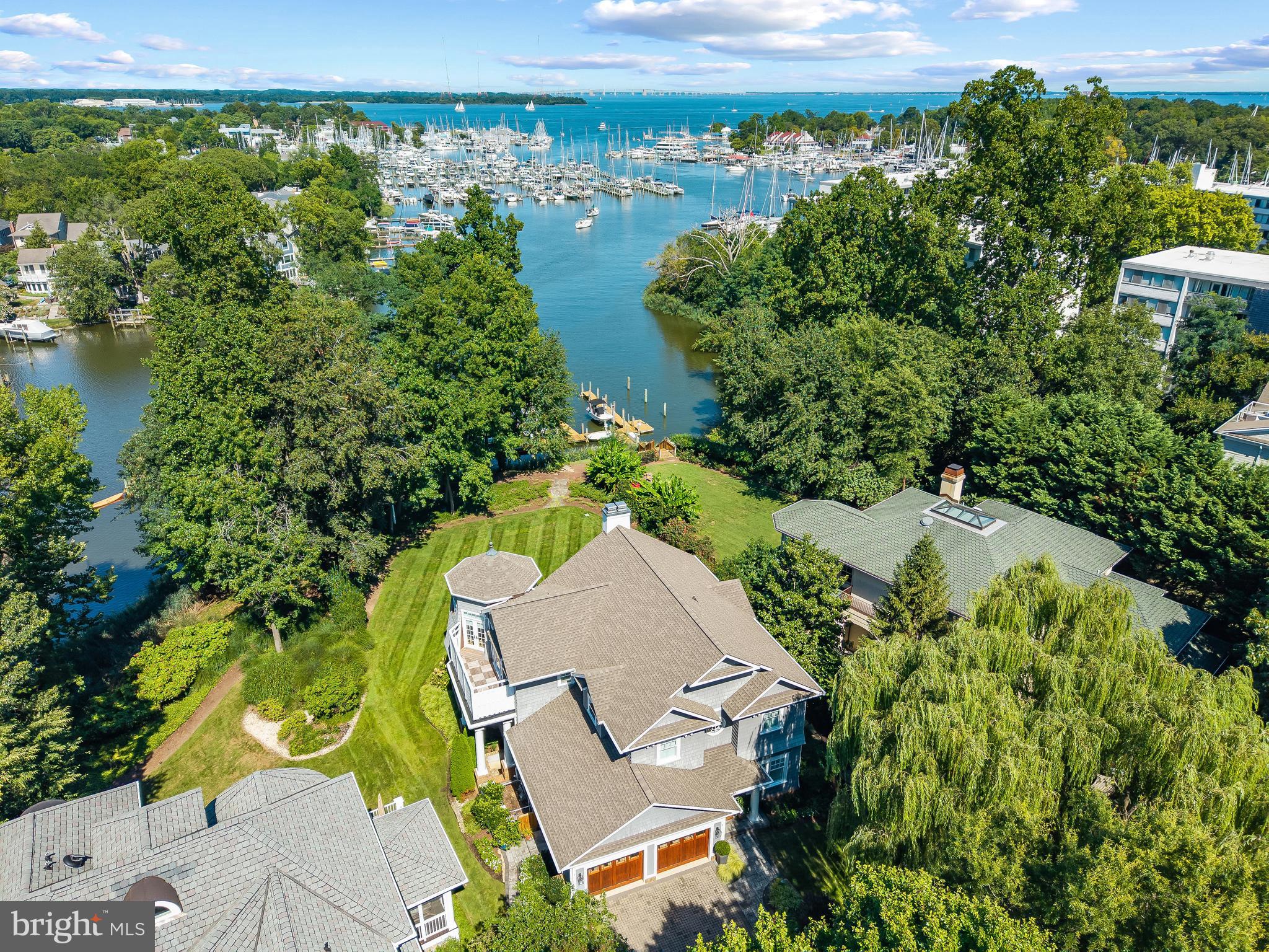 A picture perfect piece of waterfront in Eastport with views across Back Creek out to the Bay bridge. This impeccable coastal craftsman style home is beautifully appointed making it turn-key for either a forever home or a fabulous weekend escape. A rare find to be nestled in the heart of Eastport located on a serene protected creek with pier and still have expansive views up the Chesapeake Bay all the way to the Bay Bridge. The highly sought-after Eastport location is conveniently walkable to everything Eastport and Annapolis has to offer. Tucked away in a small enclave of homes, this magnificent custom home with 2 car garage was custom built to the highest standards and boasts the perfect floor plan for enjoying the water views. The community pier services the 10 homes (5 single family and 5 townhomes) in the community and your deeded boat slip is located right in your backyard with 20,000lb boat lift and 8' MLW. Inside, the thoughtful floorplan combines an open floor plan with cozy spaces for easy entertaining for small or large gatherings. Featuring beautiful hardwood floors, extensive millwork, gourmet Kitchen, 2 fireplaces, high ceilings and walls of windows that expertly capture the water views. The soaring ceilings, magnificent views, adjoining office, sitting area, fireplace, multiple balconies and spa-like bath makes the Primary's suite a relaxing private retreat to begin and end every day. The main level bedroom suite provides flexibility for one level living and with 5 bedroom, 4 full baths, 2 half baths there is plenty of room for family and friends. Outside the waterside deck and patio across the back of the home is great for dining al fresco on cool summer nights and the lush backyard is perfect for entertaining. Stroll the artful and nautical streets of Eastport to amenities like: restaurants, pubs and street-end parks. Not to mention you are merely steps away from downtown Annapolis and Naval Academy attractions. From this location, just a short cruise on Back Creek and you can venture off to some of the Bay's best cruising and fishing areas or take a turn up Spa Creek and cruise into downtown Annapolis. The historic 18th-century seaport town of Annapolis, Maryland is America's sailing capital. Annapolis offers the perfect balance of small-town charm and big world sophistication. Welcome Home!