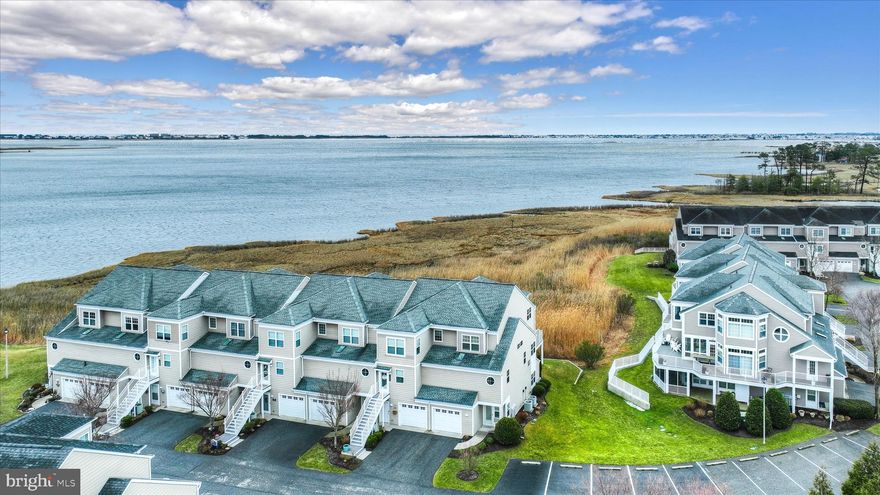 Welcome to 38348 Ocean Vista #1119, an exceptional furnished end-unit, three-level townhome in the sought-after waterfront community of Bayville Shores. Perfectly positioned to capture sweeping views of Dirickson Creek and Little Assawoman Bay, this residence offers the ease of low-maintenance coastal living with the warmth and care of a truly cherished home. Ideally situated on a quiet cul-de-sac with no thru traffic and just steps from one of the community’s two kayak launches, the setting is both peaceful and convenient.

From the beautiful wood flooring on the main level to the pristine condition throughout, every detail reflects pride of ownership, creating a move-in-ready coastal sanctuary.

The main level features a bright, open floor plan designed for comfortable living and effortless entertaining. A cozy gas fireplace anchors the great room, while expansive windows frame panoramic water views that can be enjoyed year-round. Step onto the spacious deck and feel the refreshing bay breezes while taking in elevated vistas that stretch across the water.

The gourmet kitchen is thoughtfully designed for both everyday living and special gatherings, offering abundant 42-inch cabinetry, granite countertops, stainless-steel appliances, and a convenient breakfast bar. The adjoining dining area provides the perfect space for casual meals or elegant dinners, while a well-placed powder room adds convenience for guests.

Each of the three bedrooms features its own private en-suite bath, ensuring comfort and privacy for family and visitors alike. The primary suite serves as a peaceful retreat with a walk-in closet, dual vanity, soaking tub, and separate stall shower. A welcoming sitting area within the suite showcases breathtaking creek and bay views from sunrise to sunset. A second en-suite bedroom on this level offers a comfortable space for guests or family.

The entry level provides flexible living space that works beautifully as a third bedroom or private guest retreat, complete with a full bath and direct access to a generous covered patio. This inviting outdoor area extends to the backyard and provides another relaxing space to unwind or entertain.

The garage easily accommodates your vehicle along with the gear that comes with an active coastal lifestyle.

Offered fully furnished with custom coastal décor, this home allows the next owner to begin enjoying coastal living from day one.

For water enthusiasts, the community offers a boat launch and kayak racks with direct access to Dirickson Creek. With the beach just a few miles away, residents can enjoy the best of coastal living along with outstanding community amenities including a pool, pickleball, basketball, fitness center, volleyball, shuffleboard, horseshoes, playground, and more.

Experience waterfront living at its finest in this beautifully maintained Bayville Shores retreat, where stunning views, comfortable elegance, and effortless coastal living come together.