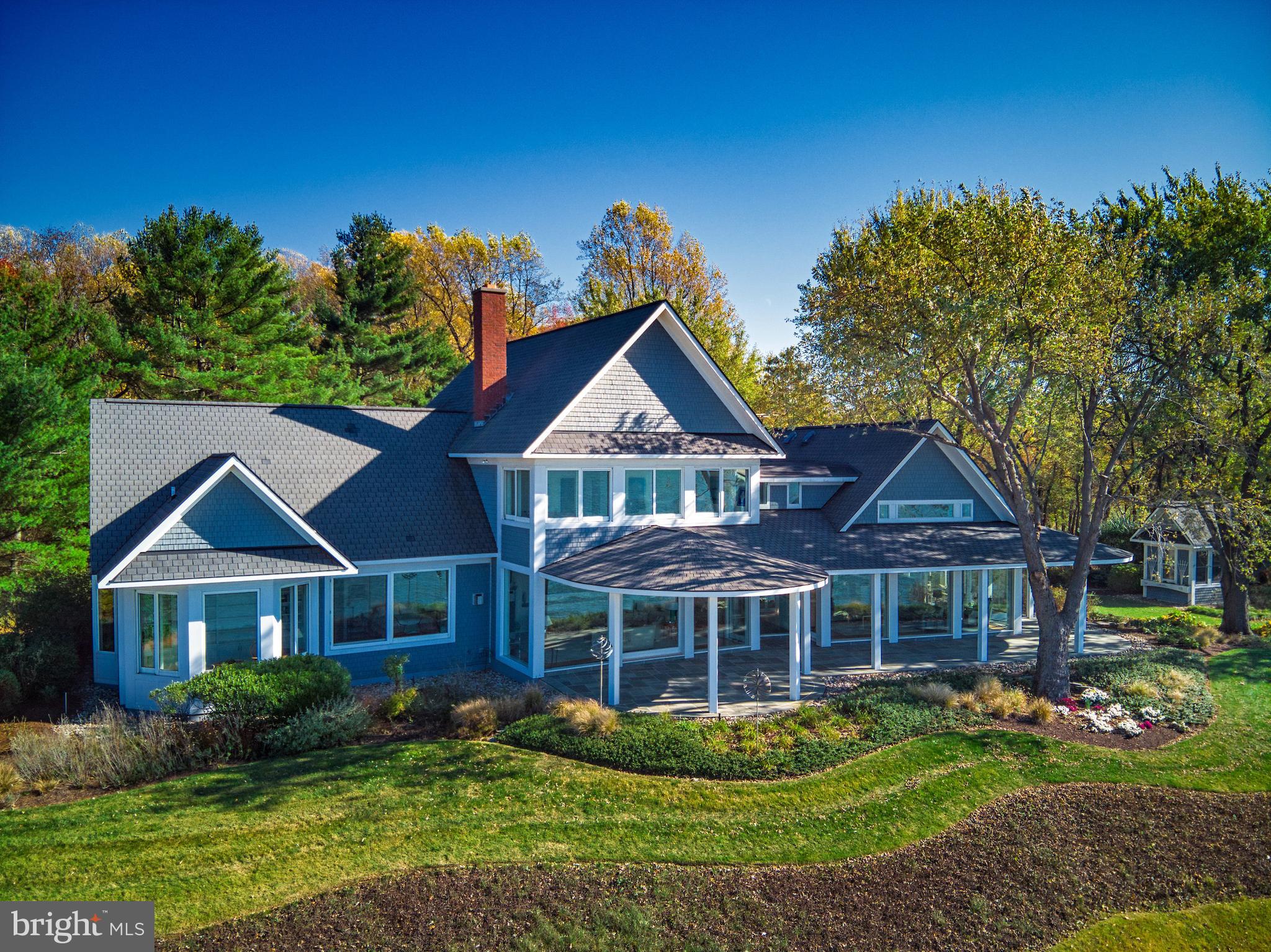 An exceptional architect-designed 6,105 square foot home perched out of the flood zone on the Chesapeake Bay - the Chesapeake/Delaware shipping channel in full view. Included in the sale is the adjacent .66 acre parcel, "LOT PAR 1-2 ON A PL S/S MONTGOMERY AVE." You'll never tire of watching the ships and daily sunsets through the floor to ceiling windows. Full of light, angles, white walls and stunning views from every window. Plenty of gallery-like spaces to display your art. A chef-designed gourmet kitchen is a cook's dream, with an adjacent butler's panty of equal size.First floor master suite has two luxurious master bathrooms finished in limestone and two custom designed walk-in closets with built-ins. Heating and cooling is provided by a geothermal system. Attached three-car garage. Dock your boat at the premier marina just a three minute drive away. Nearby is Rock Hall with more marinas, shops, restaurants, and a world-class jazz venue called the Mainstay. Twelve miles away is historic Chestertown with Washington College and more shops and restaurants. Within two hours to Philadelphia, Baltimore and DC. This is one of the finest designed homes on the Eastern Shore.