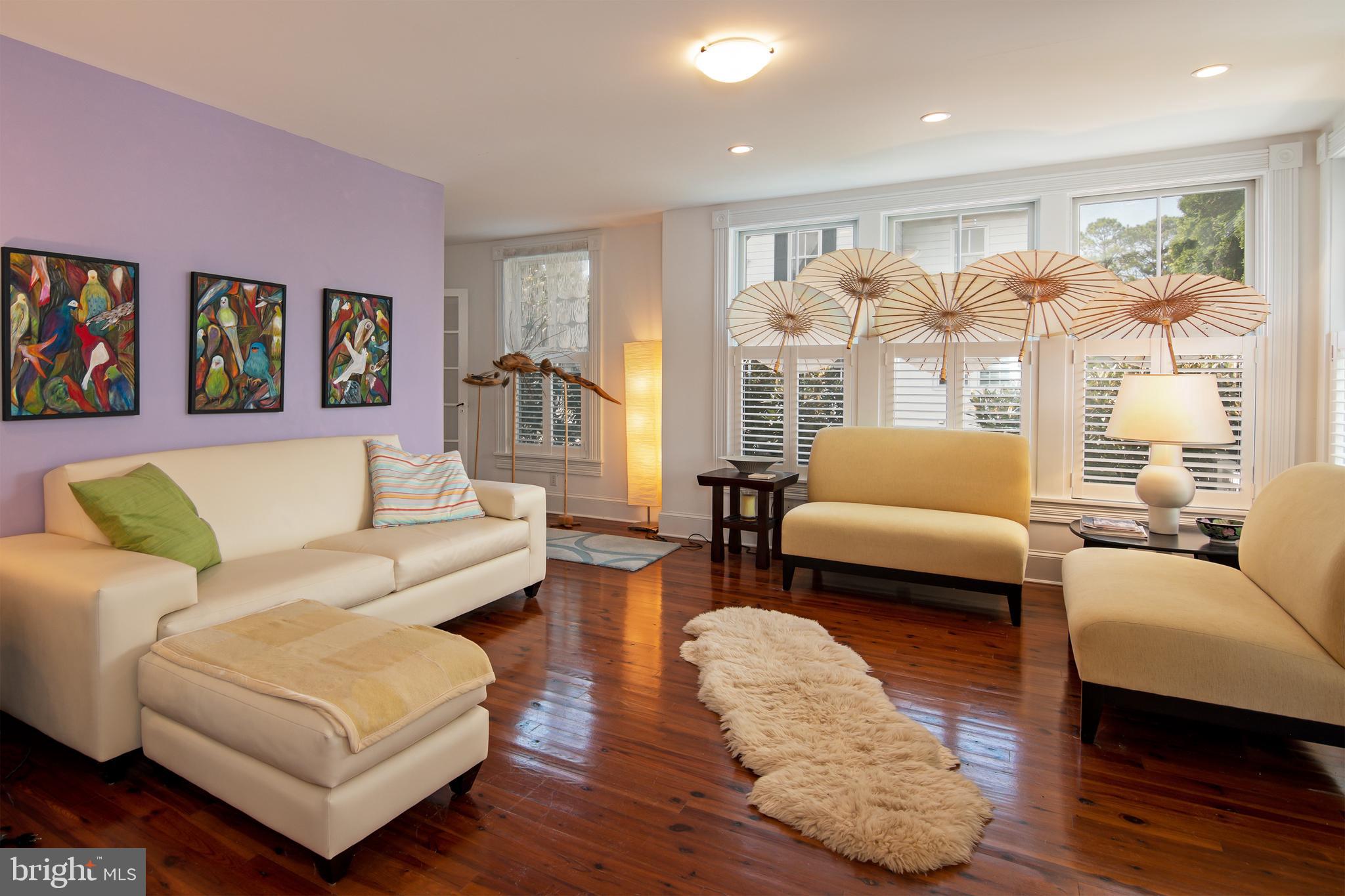 Welcome to 9 West End Avenue - a perfect blend of sophistication and tranquility. #9 is proudly sited on the corner of West End Avenue and Hambrooks Blvd...just 5 houses from the banks of the mighty Choptank River! # 9 has been quietly owned by a professional couple from DC for almost 20 years. You can see the subtle city influence in various details of every room, but, more importantly, you can glimpse the wife's artistic attention to minute details throughout this charming haven.
Charles Goebel, a highly-respected Easton architect designed the renovations and additions. The work was flawlessly executed by esteemed Cambridge builder Thom Huntington. The renovations included a new Living Room, a glamorous first-floor bathroom, and generously sized porches on the first floor, covered by a gull-winged roof. The outstanding spacious new kitchen features a multitude of light sources, a top-of-the-line propane range with hood, a built-in microwave drawer, and beautiful Carrara marble countertops and backsplash. A pass-through bar area to the dining room provides a great casual seating arrangement in addition to the formal dining room.
The upstairs second floor offers 3 bedrooms and a full bath but the most captivating aspect of the 2nd floor is the beautiful balcony off the central hall. The balcony has views of the river and the beautifully landscaped garden. In total, there are 4 outdoor porches and balconies. The back garden is an amazing oasis of specimen plantings and magnificent trees. The well-placed potting shed makes gardening a delight. The front porch's trompe l'oeil floor and sky ceiling were designed and painted by Mike Rosato, a locally acclaimed artist whose work can be found throughout the city and in numerous museums throughout the country.
#9 West End's location is ideal for strolling to the Farmers Market or the Cambridge Yacht Club and is just a short walk to all of the downtown restaurants, galleries, and shops. The renaissance in Cambridge is alive and flourishing.