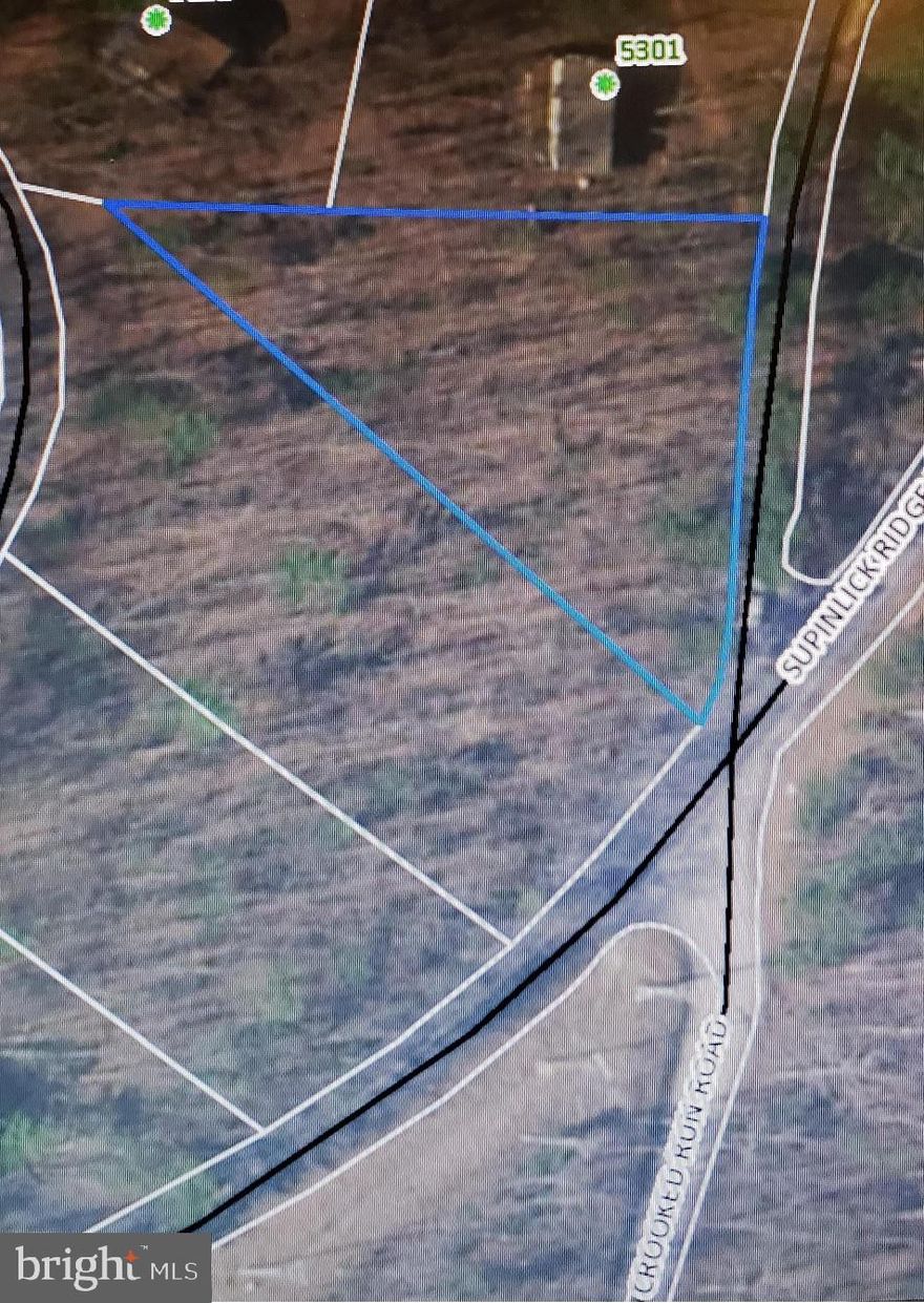 This is a lovely, corner wooded lot . A perfect spot for a Vacation or Full-time home!