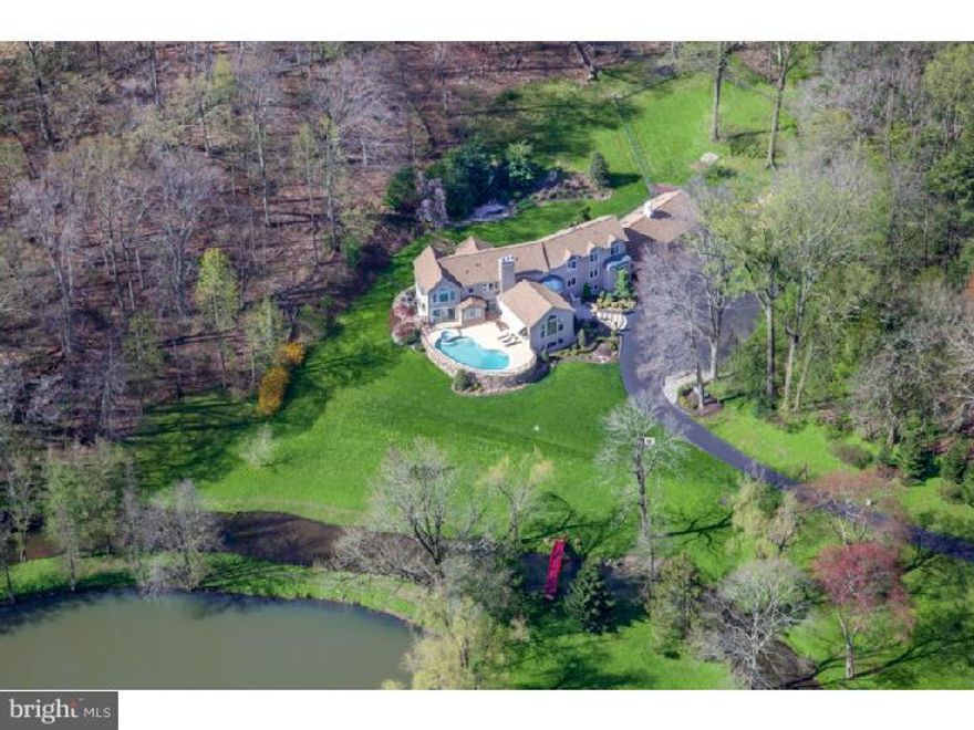 Once in a great while, a magnificent property like this, comes on the market. The nearly 20 gorgeous acres is adorned with mature trees and woodlands, open manicured lawns, wooded trails, and the pi ce de r sistance, historic "DOVE LAKE". Another outstanding feature, steeped in history, is the famous Mill Creek, running the entire length of the property, terminating with a wonderful waterfall/dam. Ideally positioned to take advantage of the breathtaking views and natural features this property has to offer, sits a stunning 12,000+- sq. ft. Custom French Contemporary home, complete with three glorious levels of luxurious living. First and second floor master suites accompanied by large windows, with captivating views, above grade finished lower level with restaurant style bar, nearly new heat and air conditioning, indoor resistance pool, elevated in ground pool overlooking  the lawns, creek and lake. Top of the line finishing's, garage parking for six cars complete this one of a kind offering. A portion of the property is under a conservation easement, protecting these rare natural resources for all eternity.