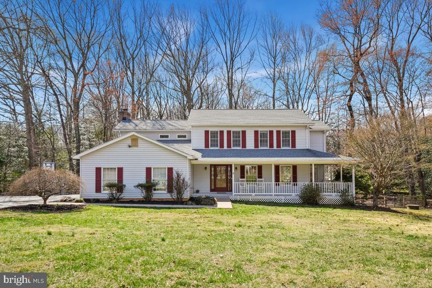 Welcome to your dream home in the heart of Prince William County and the highly sought after Coles/Benton/Colgan school pyramid. This property features a large 1.35 acre relatively flat lot with a wooded backyard and a huge front yard with a charming front porch. Inside, you'll find gleaming wood floors throughout the main level. Upon entry you are greeted with a large living room and separate dining room. The kitchen is stunning and has been recently renovated (2021). It was updated with new cabinets, quartz countertops and stainless steel appliances. The kitchen is open to a sizeable family room with fireplace. Rear doors off the breakfast area lead you to a private enclosed screened in porch and composite deck perfect for outdoor living and entertaining. Head upstairs to the large owner's suite with wood floors, a walk-in closet and luxurious primary bathroom that includes a soaking tub, separate shower and dual vanity. The second bedroom also has a private en-suite bathroom. In the basement you will find a finished recreation room and den with a walk out to the back yard. This house has a newer roof (2020) and new dual zoned HVAC (upper unit 2022 and lower unit 2023). Very low key HOA. Truly move in ready!!