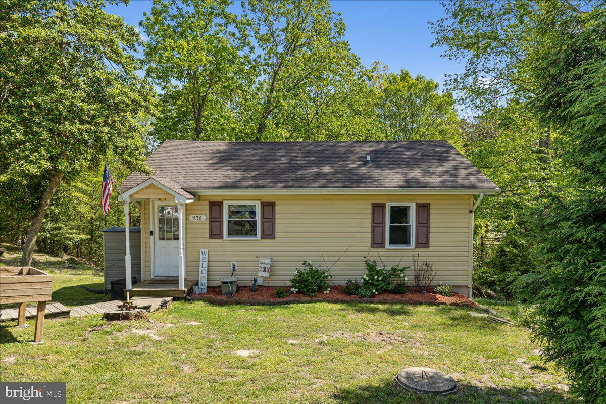 Where else can you find a 3-bedroom, 2 full bathroom home with a fully finished basement in Lusby?
"Charming" doesn't even begin to cover it. From the moment you step into the foyer, you're greeted with an open and inviting view straight through the heart of the home. Vaulted wood ceilings with exposed beams (yes, straight off your Pinterest board) pair beautifully with the hardwood floors throughout the main level. The kitchen features stainless steel appliances, tons of counter space, and a layout that makes both cooking and entertaining easy. Downstairs, the fully finished basement includes the third bedroom, a second full bathroom, luxury vinyl plank flooring, and a wet bar — ideal for game nights, guests, or simply relaxing. Major updates include HVAC (2021), roof (2016), and hot water heater (2018), offering peace of mind for years to come. And speaking of peace… you're just a short walk to the community beach. Bonus: unlike most homes in the area, this one offers two dedicated driveway spots plus two additional parking spaces — room for everyone.