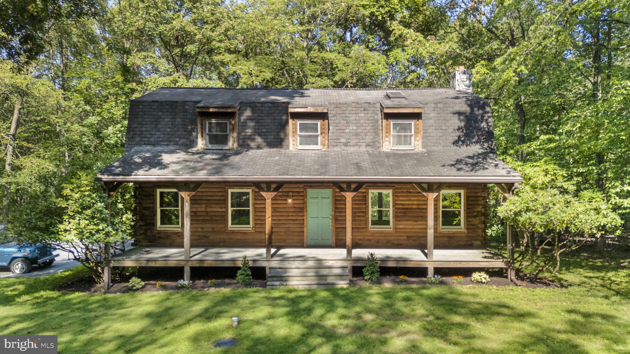 A beautiful genuine log home nestled in the wooded, desirable Mountaineer Village where each
home sits on plenty of acreage. This is a unique opportunity to live in a location amidst the
trees offering peace, privacy and a connection to nature while also enjoying a neighborhood
feel. This one-owner home has been meticulously designed and maintained. Its select features
from the striking 6” cedar logs to the custom millwork, solid interior wood doors and high end
finishes reveal how every detail has been thoughtfully curated to create a warm and inviting
retreat.
The main floor features a grand 2-story foyer entryway including a hall closet and half-
bathroom. The kitchen is equipped with custom solid maple cabinetry, butcher block counters
and stainless steel appliances giving a quality feel and functionality to the space. Open to the
kitchen is a spacious dining room. Also on this floor is a large living room with working fireplace
and access to an exterior deck, both providing a large space for entertaining. The kitchen and
foyer showcase premium tile set over cement board flooring for lasting performance while both
living and dining rooms are outfitted with 3/4” solid red oak hardwood flooring which is
timeless and built to last.
The upper level features a primary suite, two spacious bedrooms, a full bathroom, hallway linen
and storage closets, and pull down access to a sizable lighted attic with plywood flooring
above for added storage. The primary suite is a true sanctuary, complete with a beautiful view
looking out the exclusive balcony, in-suite bathroom and large walk-in closet. The primary
bathroom is one you would find in a magazine! The space features a cathedral ceiling with
chandelier, two separate vanities and frameless glass shower enclosure. The travertine tile and
heated floor add comfort and an elegant spa atmosphere.
The finished basement provides entertainment and play areas, as well as a space for your
home office needs or extra bedroom. The large family room features a working wood burning
stove, utility room access and Bilco door exit. This area also includes designated feeds through
walls/ceiling for a more discreet management of media equipment cables and wires, ideal for a
high-tech set-up. The basement was constructed with 10 foot insulated Superior Concrete Wall
System and has Pergo flooring throughout.
This property includes an existing foundation for a 3.5 bay garage that can be added at any
time. There is a 16’ x 22’ shed off the driveway. Adjacent to the shed sits 14’ x14’ paver pad
area ideal for a fire pit with outdoor seating. Located within the Twin Valley School District and
and a convenient few miles from both the PA turnpike and I-176, this home offers the perfect
combination of rustic charm and modern sophistication with room to grow. Schedule a private
tour today to experience the craftsmanship and comfort firsthand. One year of a home warranty is being offered to any buyer writing an offer.