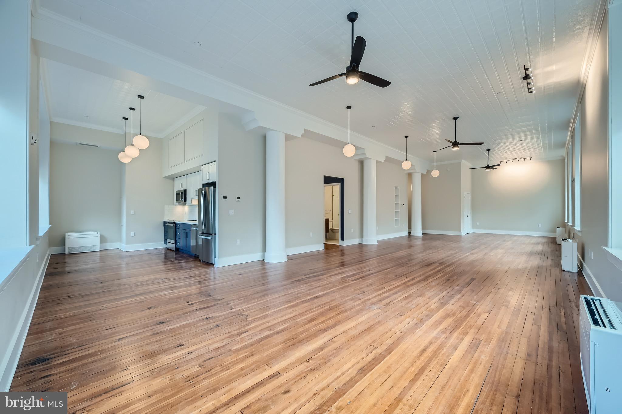 Unlike any other apartments in Baltimore! Newly renovated Open Live/Work lofts. If you are looking for expansive space – and something historically special – you owe it to yourself to visit the Crook Horner Lofts before you rent anywhere else. Located at the corner of North Howard and West Saratoga, the Crook Horner Lofts will bring 15 units of expansive open loft apartments to downtown Baltimore along with two lively street-level spaces. Built in 1890 for Crook Horner & Co. Plumbing Supplies, and later housing Pollackʼs Furniture and Rugs for many decades, 303 North Howard features soaring 14-foot ceilings, dramatic arched windows, and open floor plans. New York City-based B&B Urban worked with Baltimore-based the Civic Group to renovate these historic properties, honoring the buildingsʼ past while creating dramatic and unusually spacious live and work loft apartments.