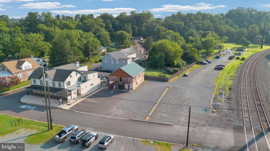 Welcome to the land lot adjacent to The Railroad Street Bar & Grill – formerly the Linfield Railroad Station and a cherished landmark in the heart of Linfield, PA. This iconic Mixed-Use property ( land + established business) has been thoughtfully transformed into a thriving Bar and Restaurant that serves as a cornerstone of the local community. The Main level features a fully operational, well-established Bar and Dining area, known throughout the region for its legendary grilled cheese sandwiches and whimsical wall of magnets – a signature touch that draws loyal patrons and curious newcomers alike. Above the Restaurant, multiple well-maintained efficiency-style apartments provide consistent rental income offering immediate cash flow. Adjacent to the Main building, a detached Barn/Garage features a beautiful new build, spacious 2-bedroom apartment—ideal as an owner's unit, Airbnb opportunity, or additional long-term rental. This rare offering combines historical charm, strong income potential, and a popular location in a community poised for continued growth with a strong focus on the future development along the rail corridor...imagine the possibilities!  Whether you're an investor seeking a turnkey income property or an entrepreneur ready to take the reins of a beloved local business, Railroad Street Bar & Grill offers a truly unique opportunity. Don’t miss your chance to own a piece of Linfield’s legacy. Schedule your private tour today!