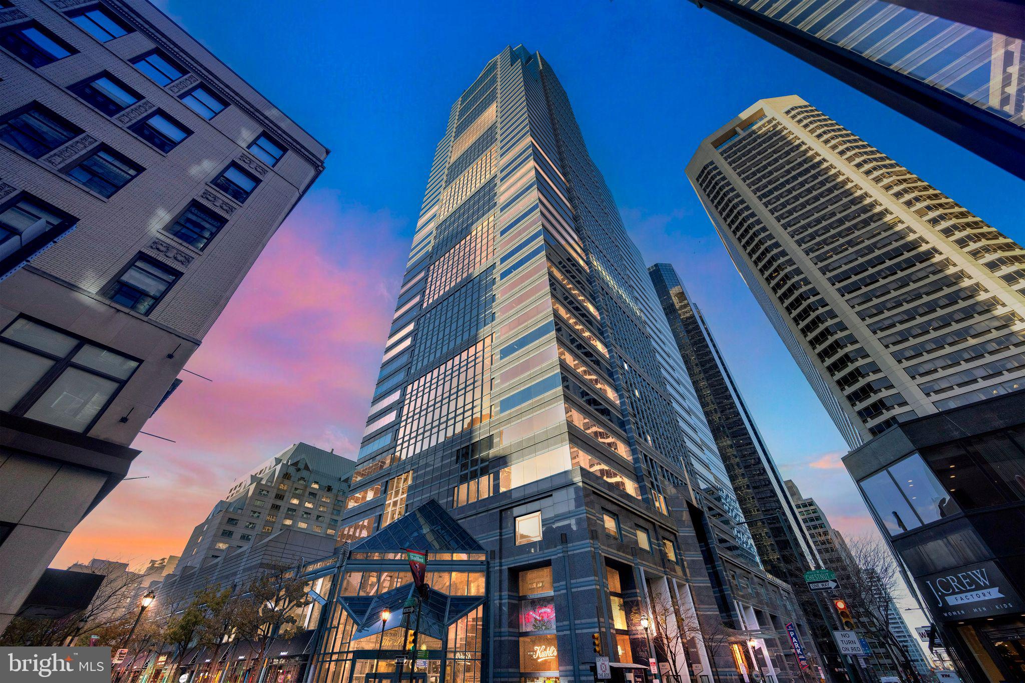 Live in the heart of Center City in a gorgeous, bright corner unit at The Residences at Two Liberty. This 2 bedroom, 2 bathroom unit has North and East facing windows that offer fabulous and unobstructed views of the river and city. The living / dining areas feature beautiful hardwood floors, a wall of windows and a stunning glass chandelier. The gourmet kitchen is complete with granite countertops, bright white Snaidero cabinetry, a beautiful glass tiled backsplash as well as stainless Miele appliances and a Sub-zero refrigerator. The wall of windows continue into the light filled primary suite which features a spectacular accent wall. The en-suite bathroom features a double vanity with marble countertops, a glass enclosed shower and separate bath. A custom walk through closet with built in organizers completes the space. The second bedroom is spacious and has a bathroom just across the hall and a large closet. The laundry area has high efficiency stacked washer and dryer. The building is secure with a private resident's lobby with door staff and concierge, at your service 24/7, in addition to elevators with fobbed access. On the newly renovated 37th floor you will have access to the finest amenities: a 24hr fitness center/spa with endless pool, steam showers, sauna, yoga studio and massage rooms. In addition, there is a business center with board room, media and billiard room. Valet parking is available at an additional fee. Liberty Two is surrounded by the best shops and restaurants the city has to offer, and close proximity to Rittenhouse Square and Dilworth Park.