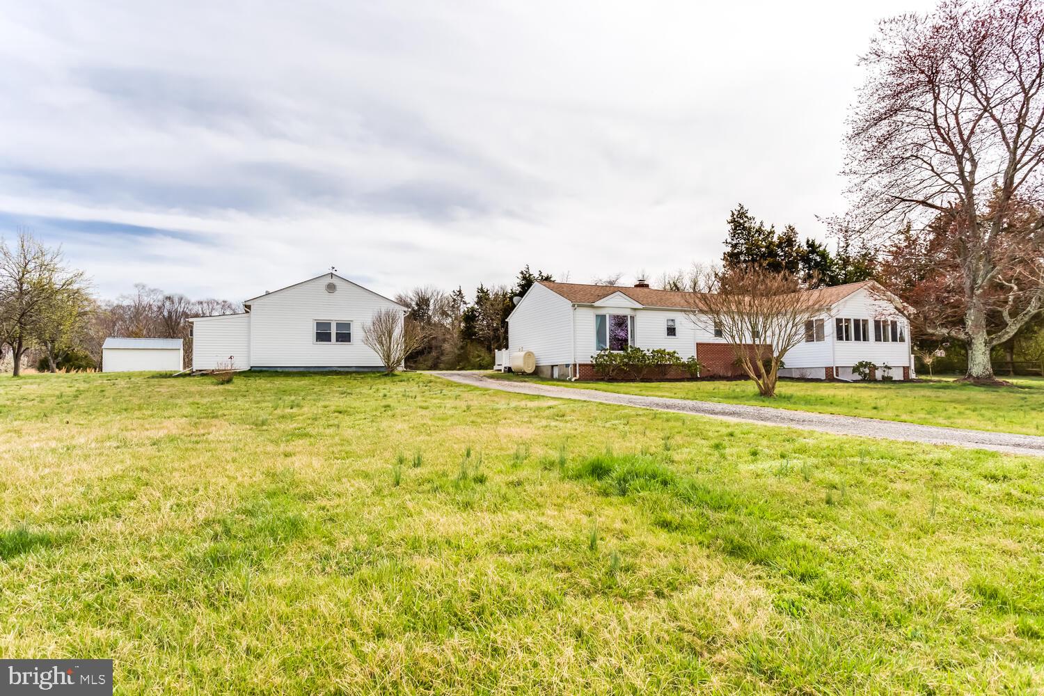100% Financing available for eligible buyers!! Nice 3 bedroom/2 full bath ranch style home situated on 1 acre just minutes from shopping, restaurants, and schools. This home is located on a quiet road and has lots of privacy in a "country like" setting. A mechanics dream with a large detached garage with a partially finished full bath & a kitchenette. Garage also has heat & AC! This home is wheelchair accessible with a ramp and ADA compliant bath. Featuring a huge owners suite with large walk-in closet and separate access to the deck through French doors. Also, a great place for family cookouts with plenty of parking! Additional outbuildings include a shed & lean-to/machine shed with electric! This property has a lot to offer and won't last long!