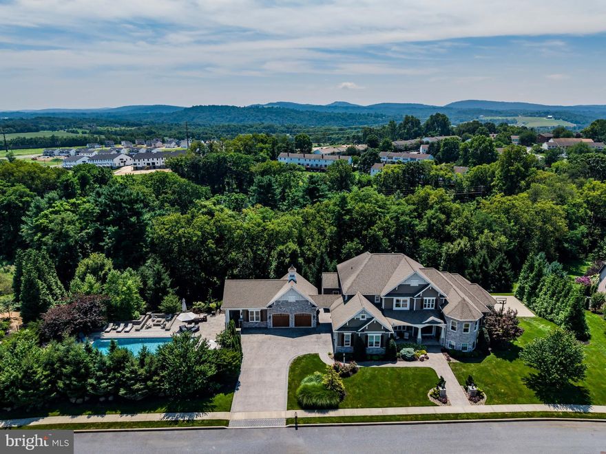 This exceptional 5 bed, 4 full & 3 half bath home blends luxury and lifestyle on nearly 1 acre—set on a rare double lot in the sought-after Mechanicsburg School District. Inside, discover soaring ceilings, intricate coffered details, elegant stonework throughout, and stained glass in the primary suite shower. Each bedroom offers its own walk-in closet, custom-designed by California Closets. Thoughtfully designed for both comfort and entertainment, the home includes a full-sized home gym, a private in-home theater, and a basketball court perfect for friendly games. Step outside to your personal retreat: a 1,500 sq ft resort-style pool with waterslide, a screened-in cabana, and a cozy fire pit for evening relaxation. With a perfect blend of luxury finishes and resort-style amenities, this home is an entertainer’s dream and a true sanctuary—all while being conveniently located near parks, schools, and more.