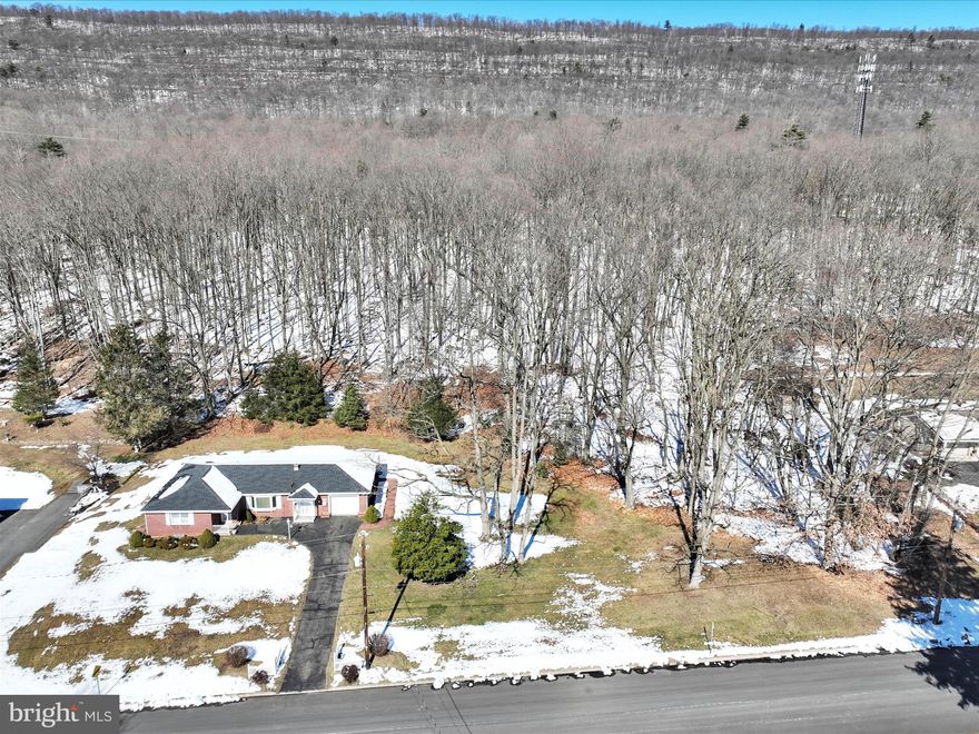 Discover the epitome of charm in this delightful all-brick ranch home, perfectly situated on nearly an acre of picturesque countryside. Boasting three bedrooms with three full baths, this residence offers ample space for comfortable living. Experience the best of both worlds with proximity to amenities while still enjoying the tranquility of a rural setting. Step into luxury with the recently renovated bathroom remodel and exquisite hardwood floors that exude timeless elegance. Indulge in relaxation within the luxurious primary suite, offering a private oasis for rejuvenation.  Appreciate the convenience of central air and public utilities, along with added bonus of an attached garage. Embrace the serenity and warmth of country living in this truly enchanting abode! All offers due by Saturday February 24th at 6:00 p.m.