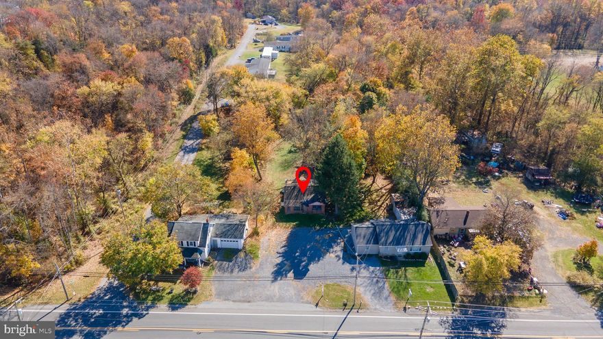 PRIME .50 acre lot on Rt. 11 in Falling Waters. COMMERCIAL OR RESIDENTIAL use. Public water & private septic system. House on the property has been gutted down to studs. SO many options here for business, home & business mixed use, multi family housing, etc.. Minutes to the Potomac River, C&O Canal, interstate, schools, shops, dining and more in this quickly growing area. BRING YOUR VISION & make it yours!