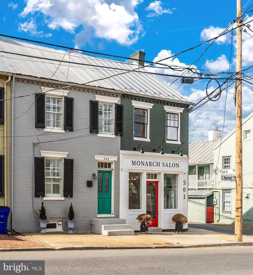 Introducing a rare, fully-remodeled historic Frederick downtown residence! This gorgeous brick home built in 1869 has all the charm and elegance of the Victorian area with all the modern upgrades you’re looking for in 2024! This move-in ready home offers generous living spaces over three floors, with 
three bedrooms, two full baths, a huge bonus room on the fully finished top floor, and off-street parking for two cars. There are refinished, original hardwood floors throughout. The brand-new, 2023 remodeled kitchen features quartz countertops with waterfall ends, custom cabinets including pantry, exposed brick walls, new picture window, waterproof LVP flooring, and top-of-the-line stainless appliances including Bosch dishwasher, GE Profile microwave and range with convection oven and induction stove, and a sleek Samsung refrigerator with flexible fridge/freezer space. Through the new Andersen glass rear door you directly access the private back patio and yard. The adjacent full bath was remodeled in 2023 and features a subway tile shower with Kohler fixtures and glass door and combined color-changing ceiling light/fan/speaker with wall and Bluetooth controls! The bath roof was replaced and additional insulation added during the remodel. The impressive entryway, living and dining rooms on the main floor feature an open flow, high ceilings, crown molding and restored antique chandeliers. The dining room also has gorgeous double crown molding and half-wall wainscotting. A split stairway leads to two wings of living space, with an office/bedroom and remodeled full bath with cast iron tub on one side. The opposite wing has two additional bedrooms with glowing hardwood floors, custom crown molding, and brand-new, modern light fixtures. The spacious main bedroom includes a large closet with built-in wood shelving. The third bedroom overlooks the quiet backyard and also has a walk-in closet with built-in wood shelving. Carpeted stairs lead up to the crown jewel of this home–a huge bonus room large enough to be both a workout and media room, an extra guest room, or a children’s playroom. This charming, warm space has exposed brick and original timber walls and wide plank hardwood floors, whitewashed beadboard ceiling, an artisan-made stair railing, and two dormer windows overlooking the rose-filled backyard with shade tree and a view of mountains in the distance. This is a wireless smart home, with Nest thermostat, CO2/smoke detector, video doorbell and rear security camera, Google “mesh” wireless internet and SimpliSafe alarm system all included. The large full-height basement has interior access directly from the kitchen. Down the hardwood and slate stairs you’ll find plenty of commercial-grade storage shelving, brand new washer and dryer on pedestals, and new upright deep freeze, all included. Gas furnace, new gas water heater, and central A/C provide modern comforts! At the rear of the home the large yard includes a standing-height workshop/shed on cement pad, brick patio and path, and a new, 6-foot privacy fence with electronic dead-bolt lock on the cedar-framed gate leading out to an elegant brick 2-car parking pad. This prime Frederick location is a commuter’s dream–access I-270, 1-70, I-15, and I-340 in minutes, without driving through downtown! Nearby, Historic Mt. Olivet Cemetery offers safe, quiet running, cycling, and dog walking paths. Walk to beautiful Baker Park, downtown shops and restaurants, and Frederick’s many outdoor concerts and festivals. Welcome to your new, walkable lifestyle!