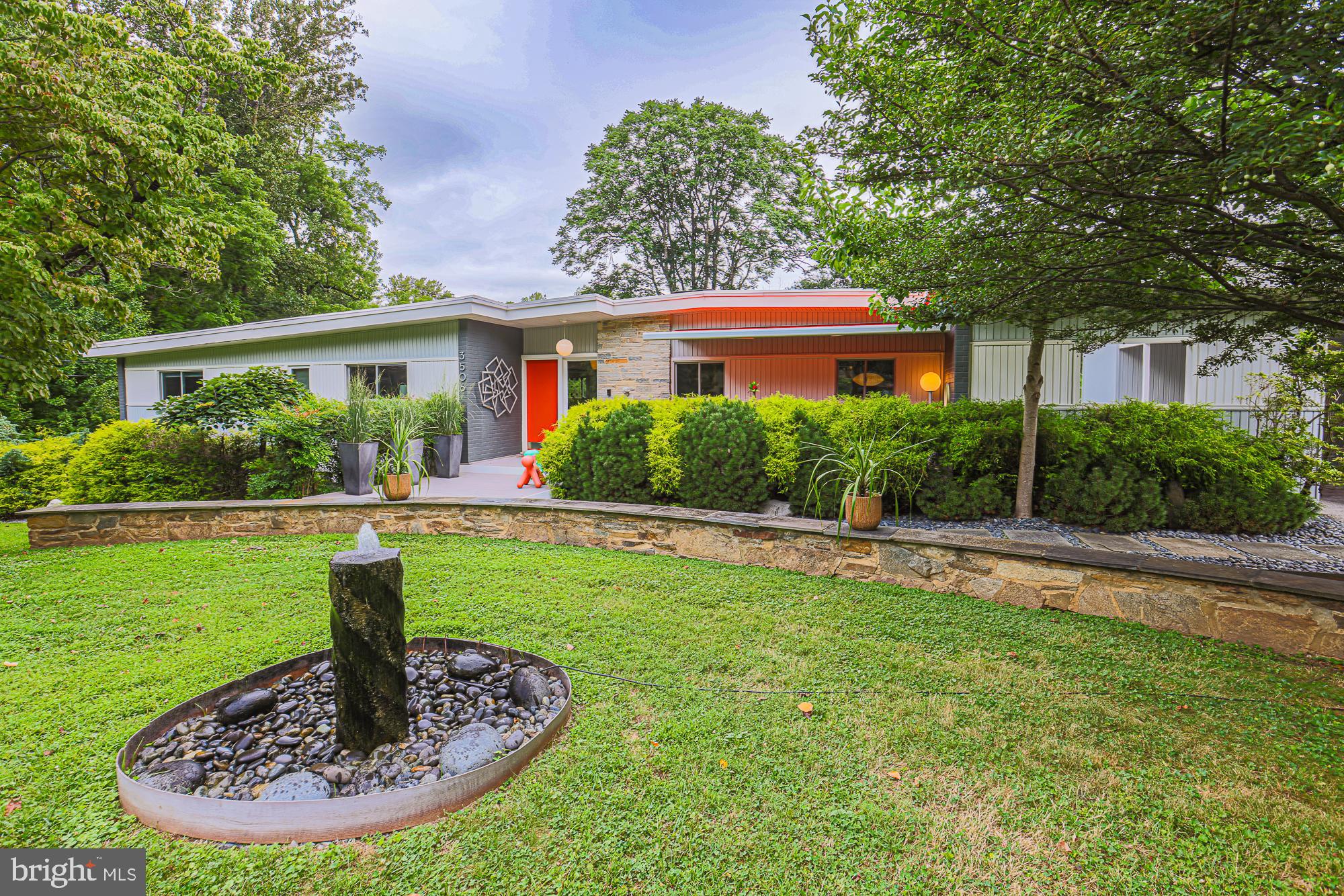 Nestled in a serene setting, this Mid Century Modern (MCM) home is a remarkable blend of style and functionality. With 5 bedrooms and 3 full baths, it beautifully showcases the essence of MCM design, featuring iconic elements reminiscent of renowned designers like Herman Miller and Knoll.
Upon entering, you're greeted by cathedral ceilings and expansive glass walls that create a seamless connection to the outside. The living room opens to a large deck, offering stunning views of the immaculate landscaping and the inviting heated pool complete with a whirlpool. This space is designed for both relaxation and entertainment.
The kitchen is a standout feature, having been highlighted in Chesapeake Home Living magazine. It boasts solid white oak cabinets, exquisitely painted grey, and is thoughtfully designed with two work triangles for efficiency. Modern amenities include an induction cooktop, a double oven, and a low-placed microwave. French doors lead from the kitchen to a decked patio equipped with a propane grill and easy access to the pool.
Every corner of this home is thoughtful; from the composite decking that requires no maintenance to the custom smooth black stone river rock, incorporated into the walkways, it’s clear that attention to detail was paramount. Natural light floods into the outdoor dining area through an opening in the exterior wall. eliminating need for curtains thanks to innovative windows and “invisible” screens.
The property is set on 1.5 acres, fully fenced for privacy and security. It also features an adorable “chicken coop” and a storage shed. The landscaping is exquisite, showcasing mature, deer-proof plants, including a rare yellow magnolia tree. For added charm, a contemporary water fountain graces the front yard.
Practical features include a carport with a workshop or studio, as well as multiple access points to the pool from different levels of the home. A bright orange retractable awning provides a cozy outdoor sitting area, further enhancing the outdoor experience.
Perfect for those seeking a turn-key MCM gem, this property is ready for September occupancy, inviting you to move in and start living the Mid Century Modern lifestyle.