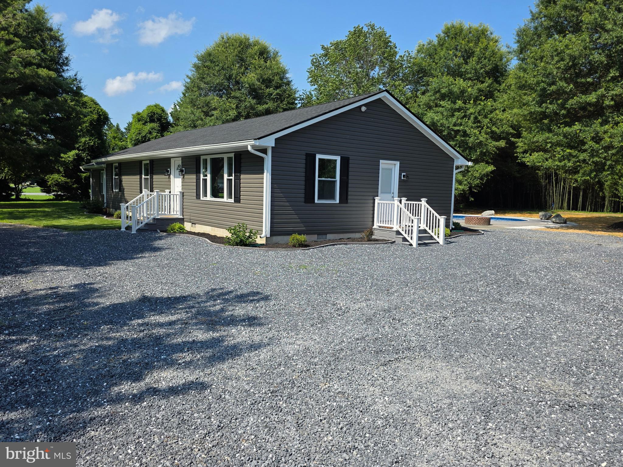 Very beautiful home on a large one-acre lot in the sought-after neighborhood of Crofton -- very rare a home goes on market here. This beautiful rancher has been totally renovated including kitchen stainless steel appliances, cabinets, farm sink with all the attachments, microwave, dishwasher, pantry, large island with gorgeous light will seat 5-6, new granite countertops, recessed lighting and window over the sink looking into backyard showcasing the beautiful in-ground pool; large open dining area with French doors leading to the all new 19 x 12-foot deck with vinyl railings and gray composite base. Also the large 18'x 11' family room with a walk-in closet and a skylight; new carpet in all bedrooms and waterproof vinyl plank flooring (Barnes Oak colored) throughout rest of the home. The living room has a very nice new bay window overlooking the front yard; This very comfortable rancher is quite roomy with an open floor plan with the living room being enjoined with the kitchen and dining area; mud/utility room between kitchen and side door from driveway, keeping wet/dirty feet and clothing from getting in rest of home; also making grocery shopping convenient to taking groceries to the pantry from the car. The garage/workshop area at the back of the home has a New 9' overhead door and a new walk-thru door. New siding, architectural roofing and gutters. The landscaping displays colorful blooms and foliage. New graveled half-circle drive with large parking area off the side of the home for family and friends for those wonderful get-togethers year round. This is a very desired area with NO city taxes yet only a very short distance, about 1 mile to Rt. 50, to everything you need in the historic town of Easton. This truly is a rare opportunity in a neighborhood known for having friendly neighbors and well kept homes, so much that no one wants to move. Move in and stay for many years also as you enjoy the stable community of Crofton!!! Come see this beauty and be prepared to say "Wow."