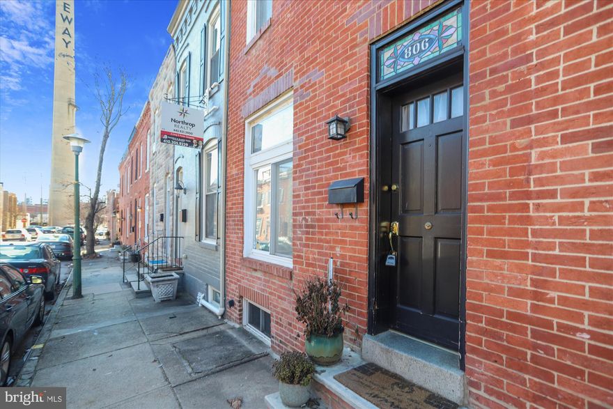 Perfect Canton rowhome in amazing location just steps away from the square with lots of Baltimore Charm! This 3 bedroom, 2 full bath has a lovely stained glass transom, wood floors, updated kitchen with stainless appliances and granite countertops, lovely French doors, a nice sized private patio AND a recently rehabbed roof deck with amazing city views. Was a grocery store at the beginning of last century and still has a hook for an Arabber out front. Recently painted and ready for a new owner!