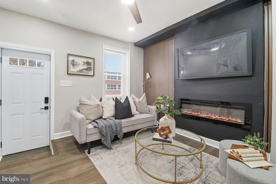 Welcome Home...This  4BR/2.5BA end of row Townhome located in the desirable neighborhood of Harlem Park.  Make your way to the front door and step inside a home completely transformed into an open main floor plan featuring recessed lighting, luxury flooring, tons of natural light, a neutral color palette and four spacious floors of living space.  The main floor features a large living room offering a custom feature wall with a gas fireplace, a spacious dining area, a half bath, and stunning kitchen. The kitchen offers plenty of cabinets including a pantry cabinet and open shelves, stainless steel appliances (like a slide-in gas range with a pot filler), sleek quartz countertops with a beautiful tiled backsplash, and a deep stainless sink under a window.  On the second floor are two sizable secondary bedrooms and a newly remodeled full bath.  The third floor hosts the third secondary bedroom, a large primary bedroom, and a full bath with a tiled walk-in shower.  The lower level is finished, newly carpeted, and offers a spacious family room, laundry, utilities, and storage. From the main floor step outside to a cozy fenced in yard ideal for summertime relaxation. Located near shopping, restaurants, and commuter routes. There are Tons of grant and down payment assistance programs available for this property based on buyer eligibility. Don't miss the opportunity to live in the heart of Baltimore.