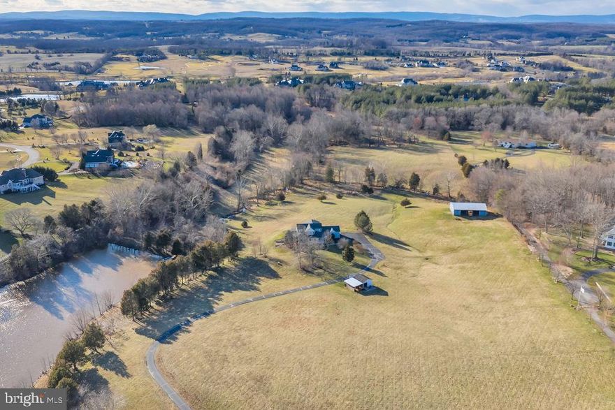 27+ACRES, PRIVATE AND SERENE, NORTH OF RT 50, BACKING TO CREIGHTON FARMS AND MULTI-MILLION DOLLAR PROPERTIES,  MEMBERSHIP TO CREIGHTON FARMS AVAILABLE!   PRIVATE ROLLING PASTURES WITH CREEK AND 2 ACRE POND, AND NO HOA!!!  4 BDR, 4 BATH HOME WITH UPDATED GOURMET KITCHEN WITH SS APPS AND MARBLE COUNTERS, UPDATED FAMILY ROOM WITH FIREPLACE AND WOOD FLOORS,  MAIN LEVEL MASTER, FINISHED LOWER LEVEL WITH WALK-OUT,  LOVELY PATIO WITH VIEWS, STOCKED POND WITH DOCK,  LARGE BARN(COULD BE USED FOR ANYTHING!), ANOTHER BARN/SHED, AN INCREDIBLE PROPERTY IN AN INCREDIBLE LOCATION!!!