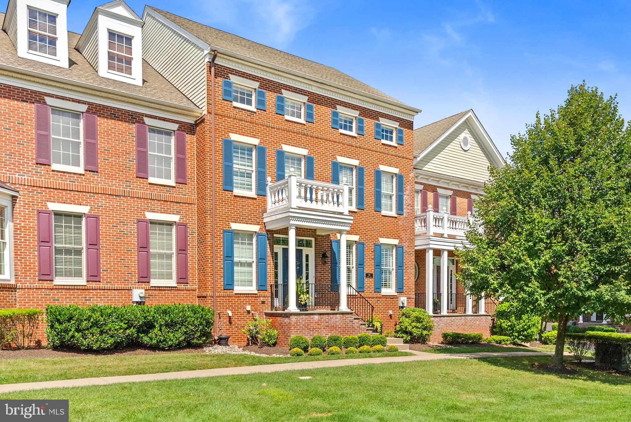 Nestled in the sought-after Newtown Walk community, this beautifully maintained townhome offers a perfect balance of comfort and functionality. Presenting impressive enhancements certain to please, guests are welcomed by refined hardwood flooring, enriched with elegant wainscoting and crown molding in the Living Room and Dining Room. The open flow leads seamlessly into the Gourmet Kitchen, featuring stainless steel Jenn Air appliances including a built-in, paneled refrigerator, granite countertops, a separate bar area with custom cabinetry and a multi-tier island with seating. The adjacent Family Room boasts floor-to-ceiling built-ins for optimal storage, a cozy gas fireplace and access to a private, maintenance-free deck with an awning. The Mudroom, conveniently located near the two-car garage, includes built-ins to keep belongings organized and out of sight. Above the garage is a fabulous upgrade, a finished Bonus Room with its own zone for heating and cooling and offers endless possibilities—a home office, gym, or creative space. On the second floor, the Main Suite is a true retreat, complete with a professionally organized walk-in closet and a luxurious NEW Bath featuring a freestanding tub, frameless shower, and dual vanities with improvements totaling $55,000. Two spacious bedrooms share a Full Hall Bath along with a convenient laundry room. The third floor offers wonderfully versatile space, currently used as a game room, but can easily function as additional sleeping accommodation with a private Full Bath. The lower level is a dream and designed for entertaining, with two Sub Zero wine refrigerators, substantial bar with granite counters and a convenient half bath. This gorgeous home offers a blend of luxury, space, and a minimal maintenance lifestyle. Additional amenities include hardwood flooring throughout, central vac system, convenient access to major roadways to Philadelphia, Princeton and transit to NYC. Located near shopping and dining, within walking distance of Newtown Boro and Roberts Ridge Park, this move-in ready home is ready to be enjoyed!